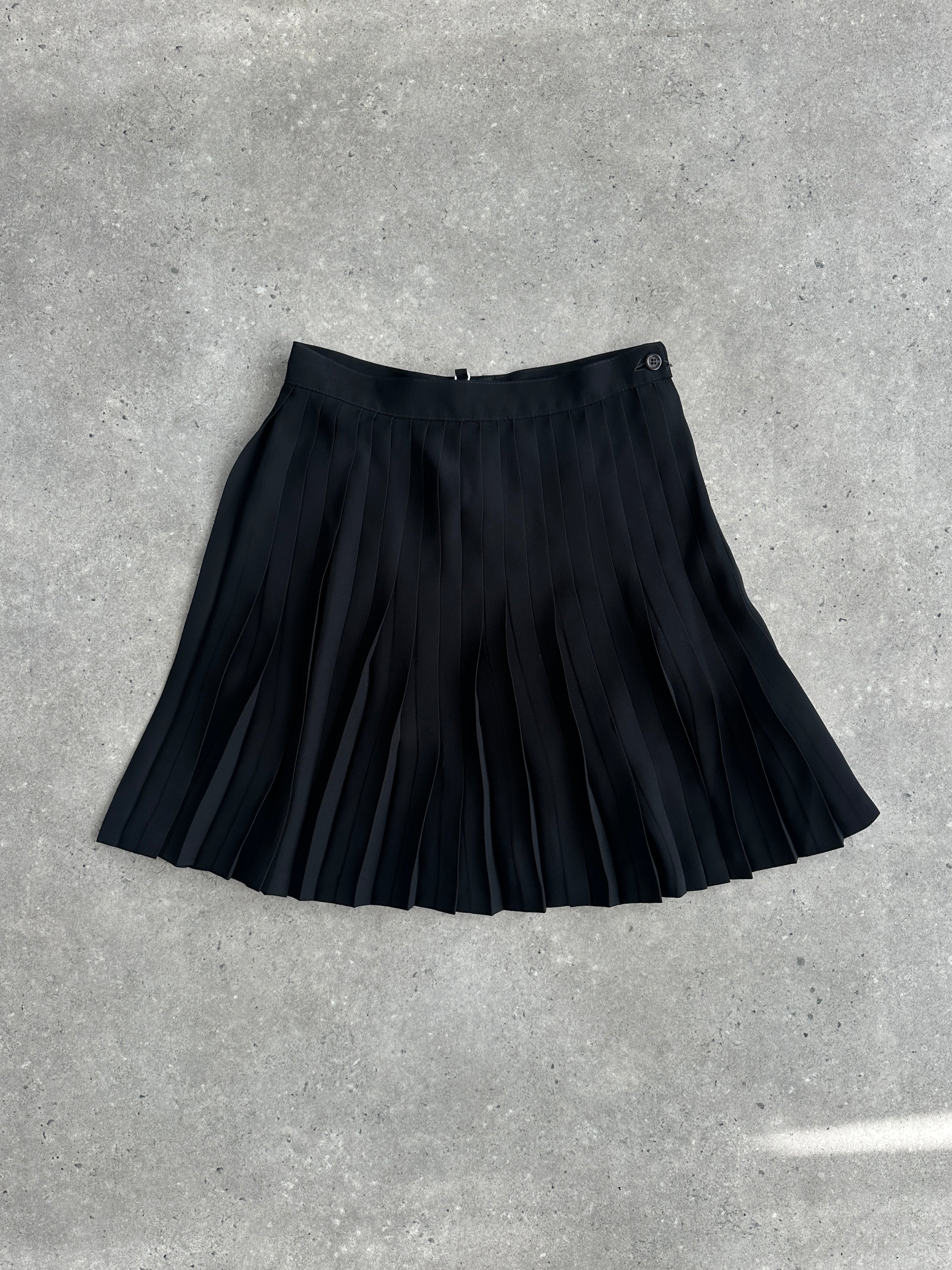 Vintage Italian 1990s pleated A-line mini skirt with a high waist and classic design, shown on a neutral background.