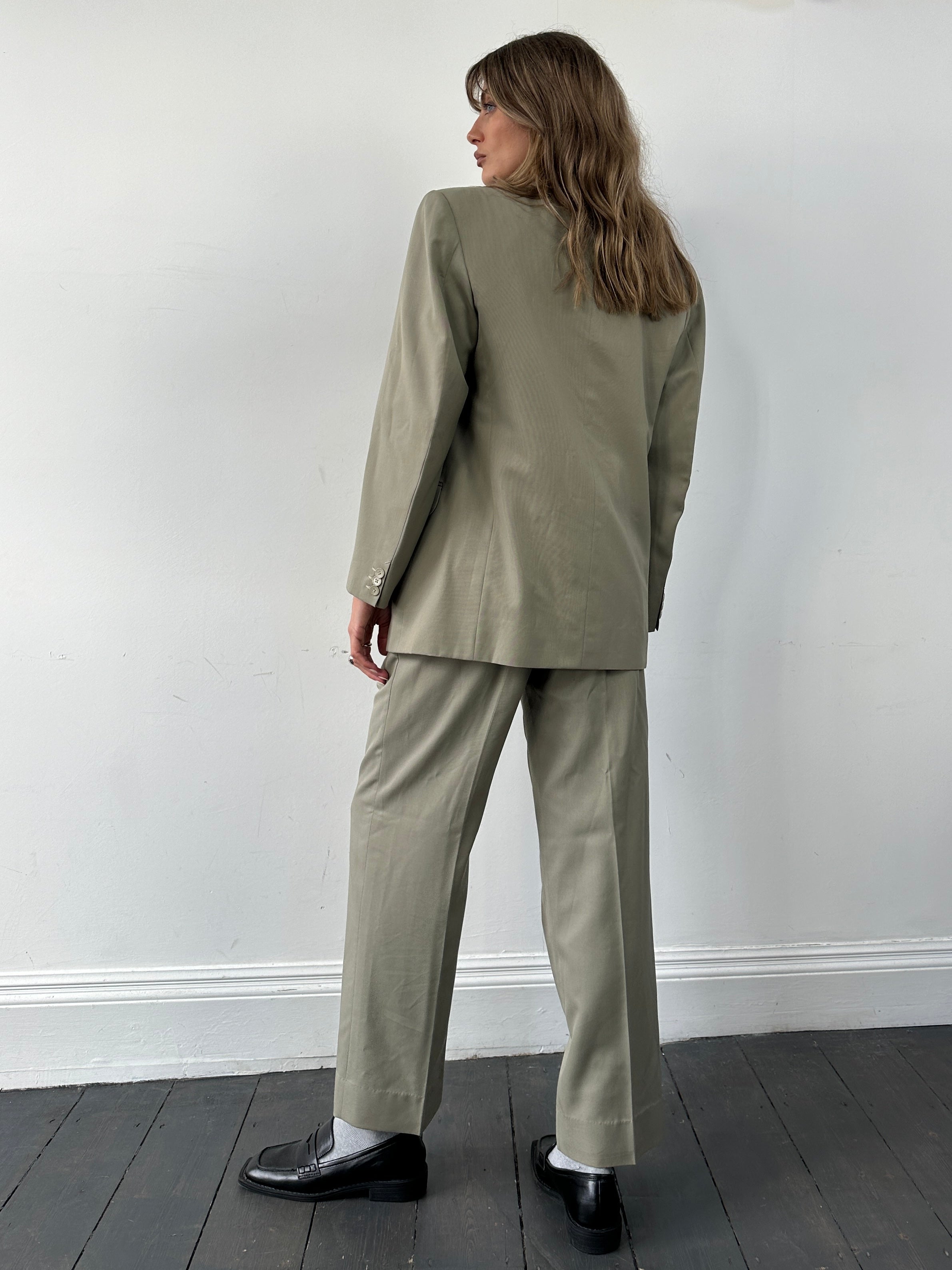 Vintage wool jumpsuit with single-breasted suit style, size 40R/W30, featuring classic tailored details and a vintage aesthetic.