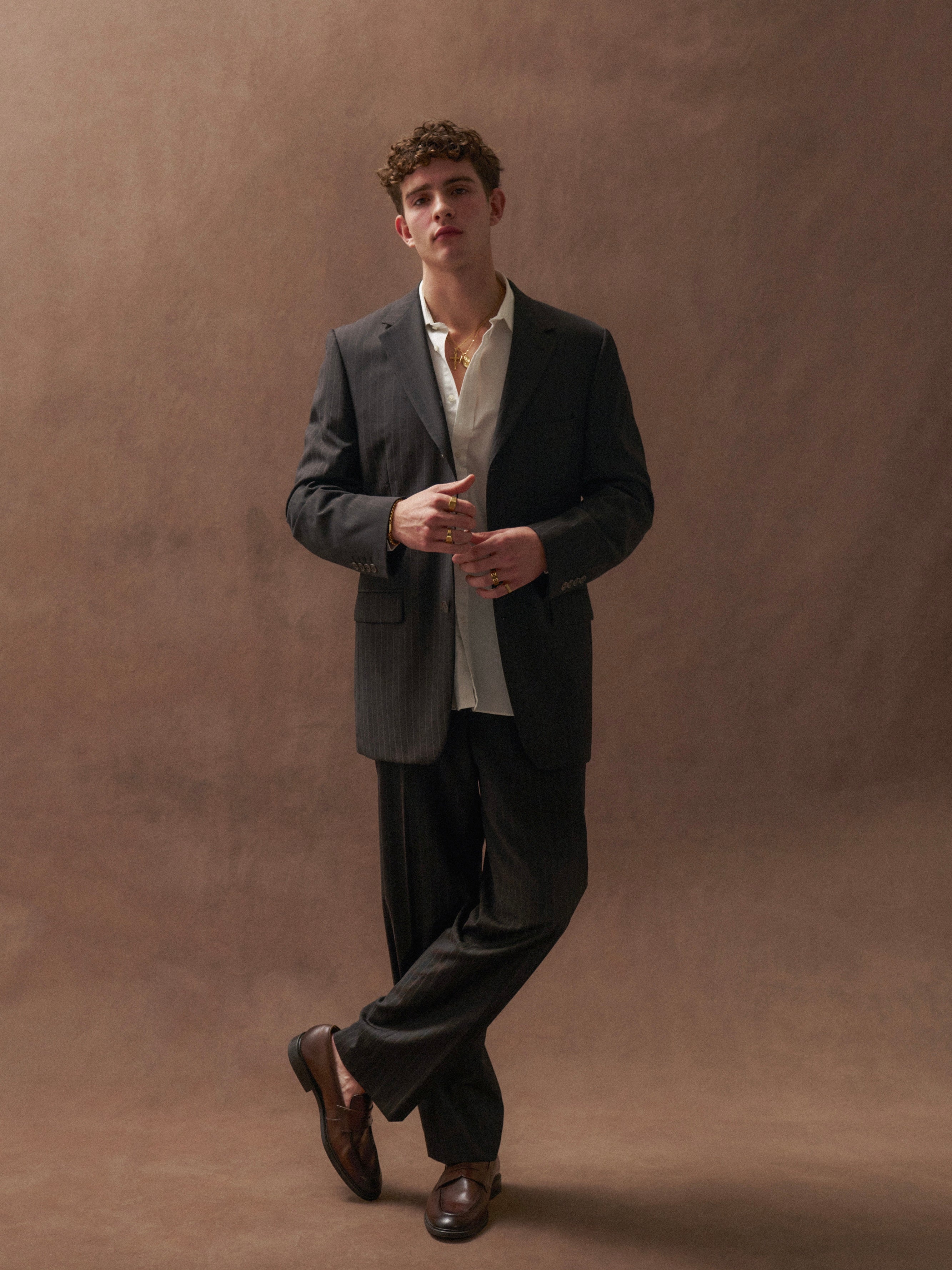 Yves Saint Laurent Pour Homme pinstripe pure wool single-breasted suit in size 40R/W32, displayed on a hanger.