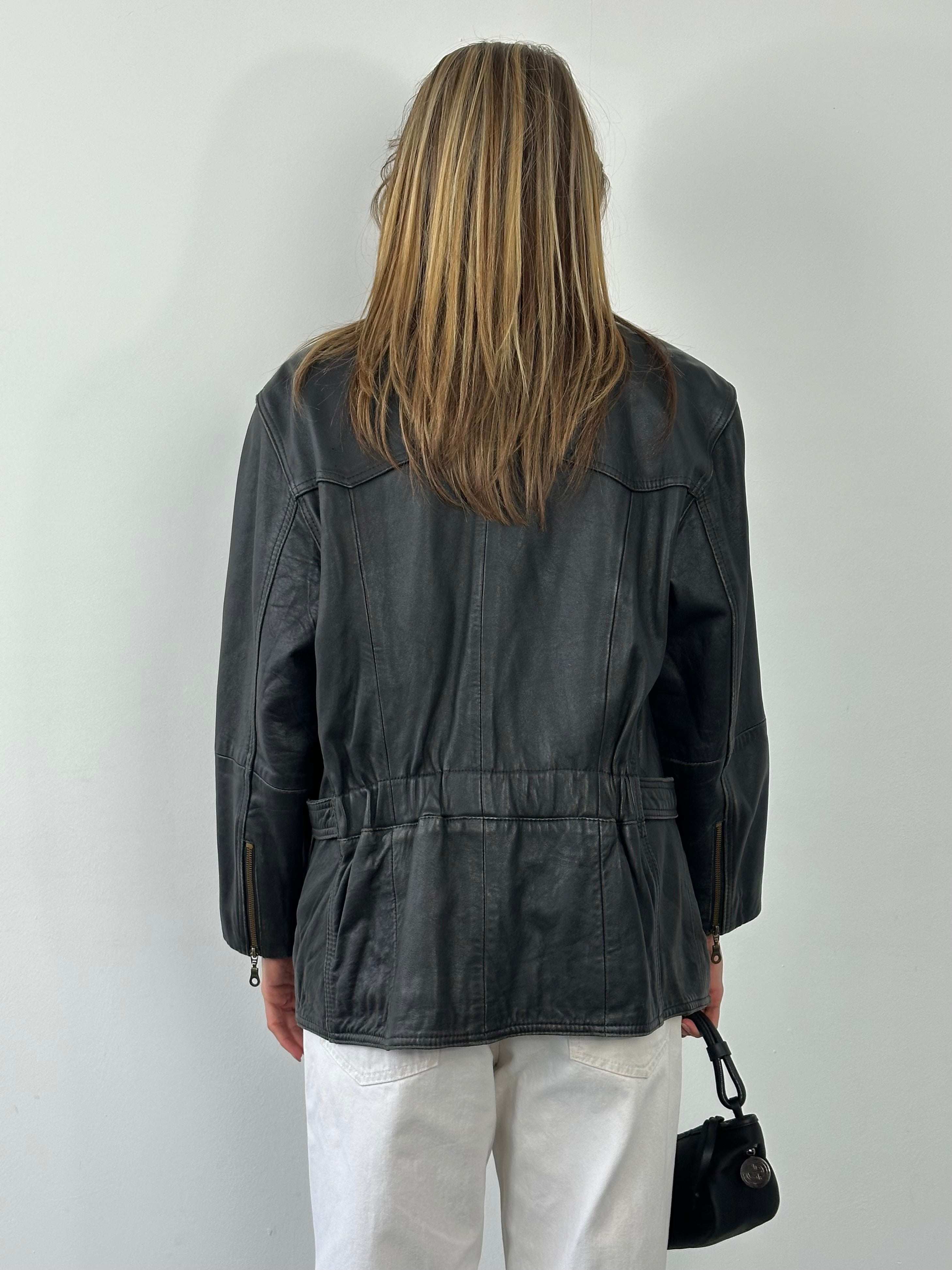 Vintage 1990s leather belted jacket in size M, showcasing classic leather material and timeless design.