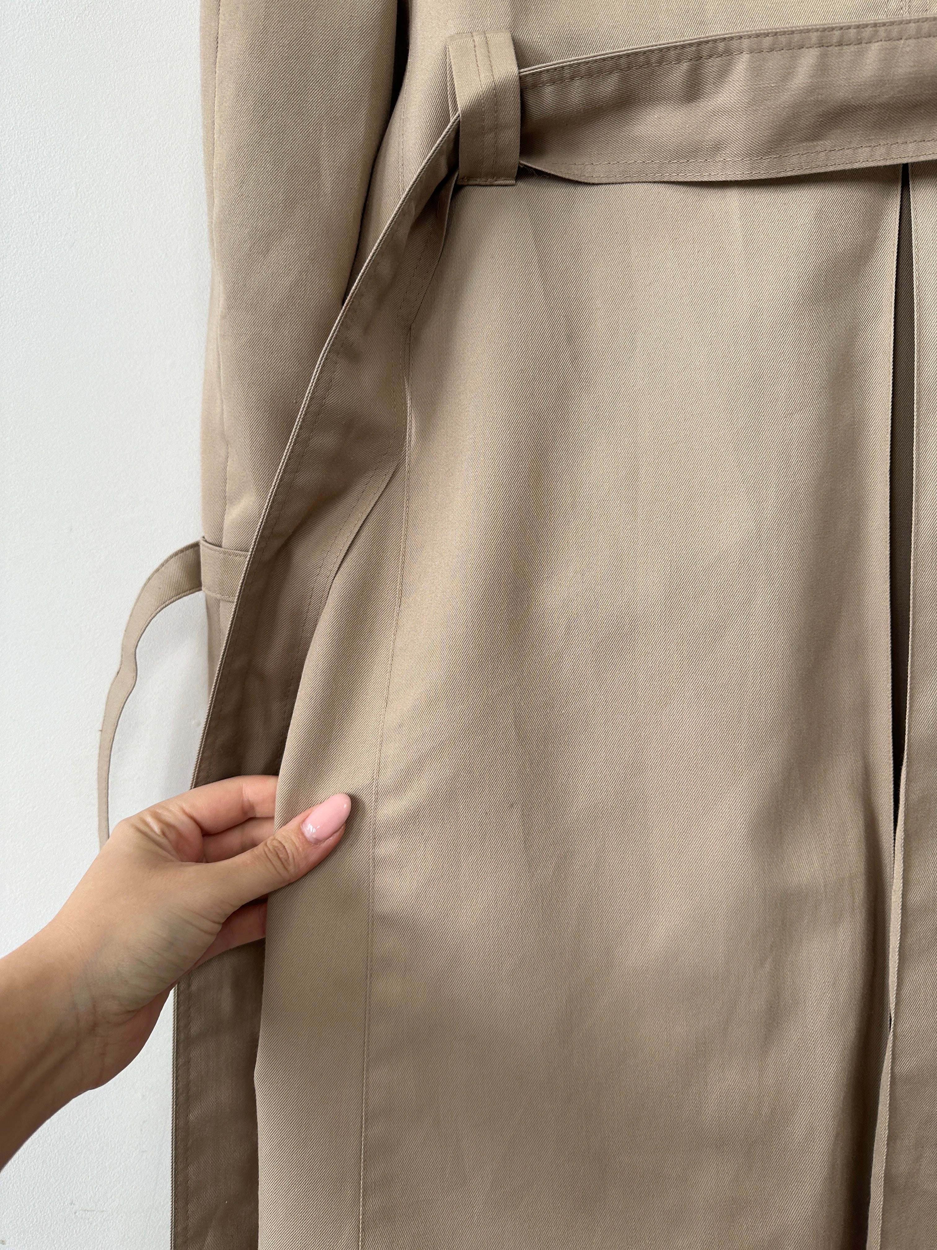 Christian Dior Monsieur double-breasted belted trench coat in beige, L/XL, displayed on a hanger in a neutral setting.