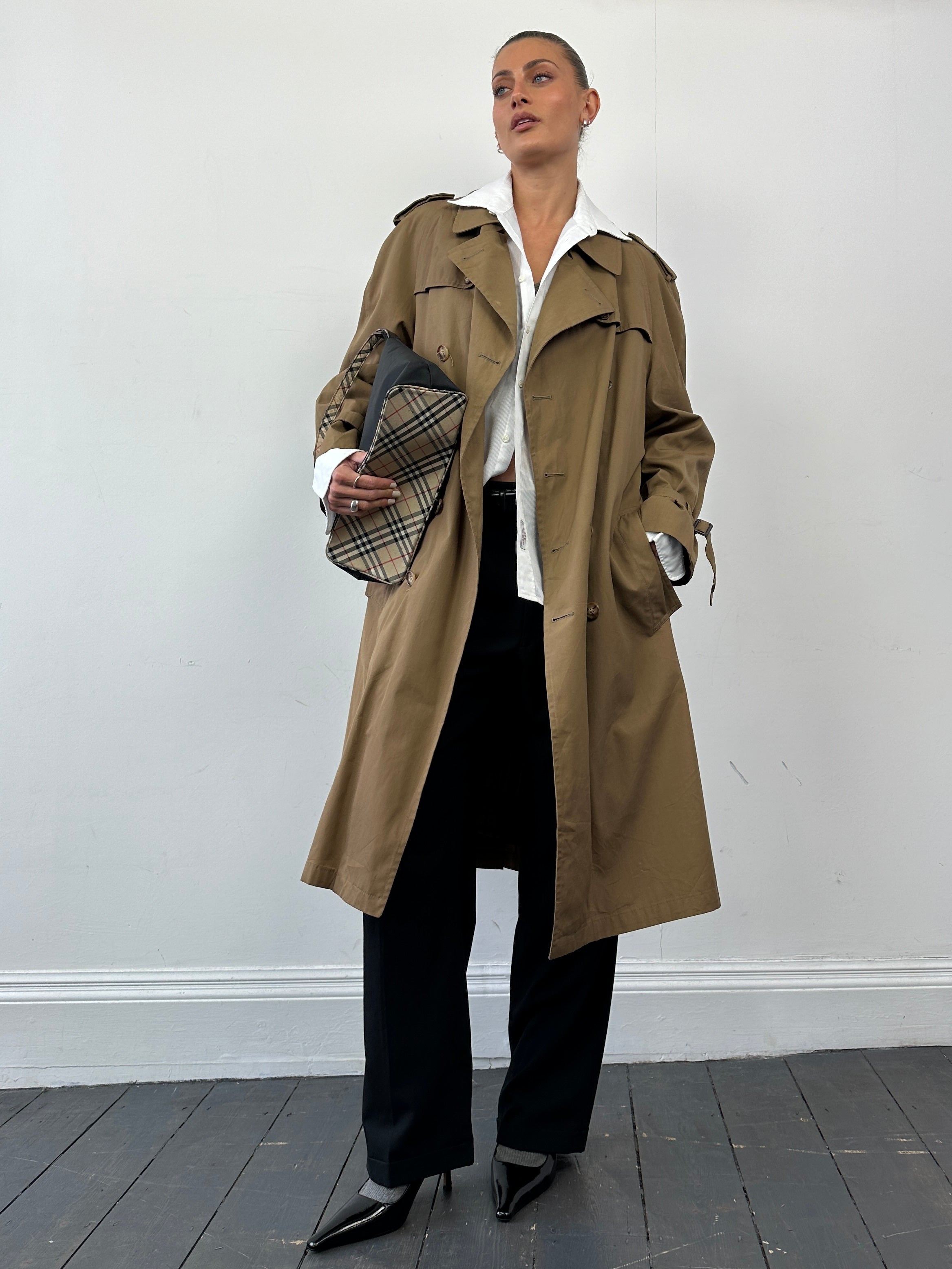 Christian Dior cotton double-breasted trench coat in size L, shown on a model with classic design and neutral color.