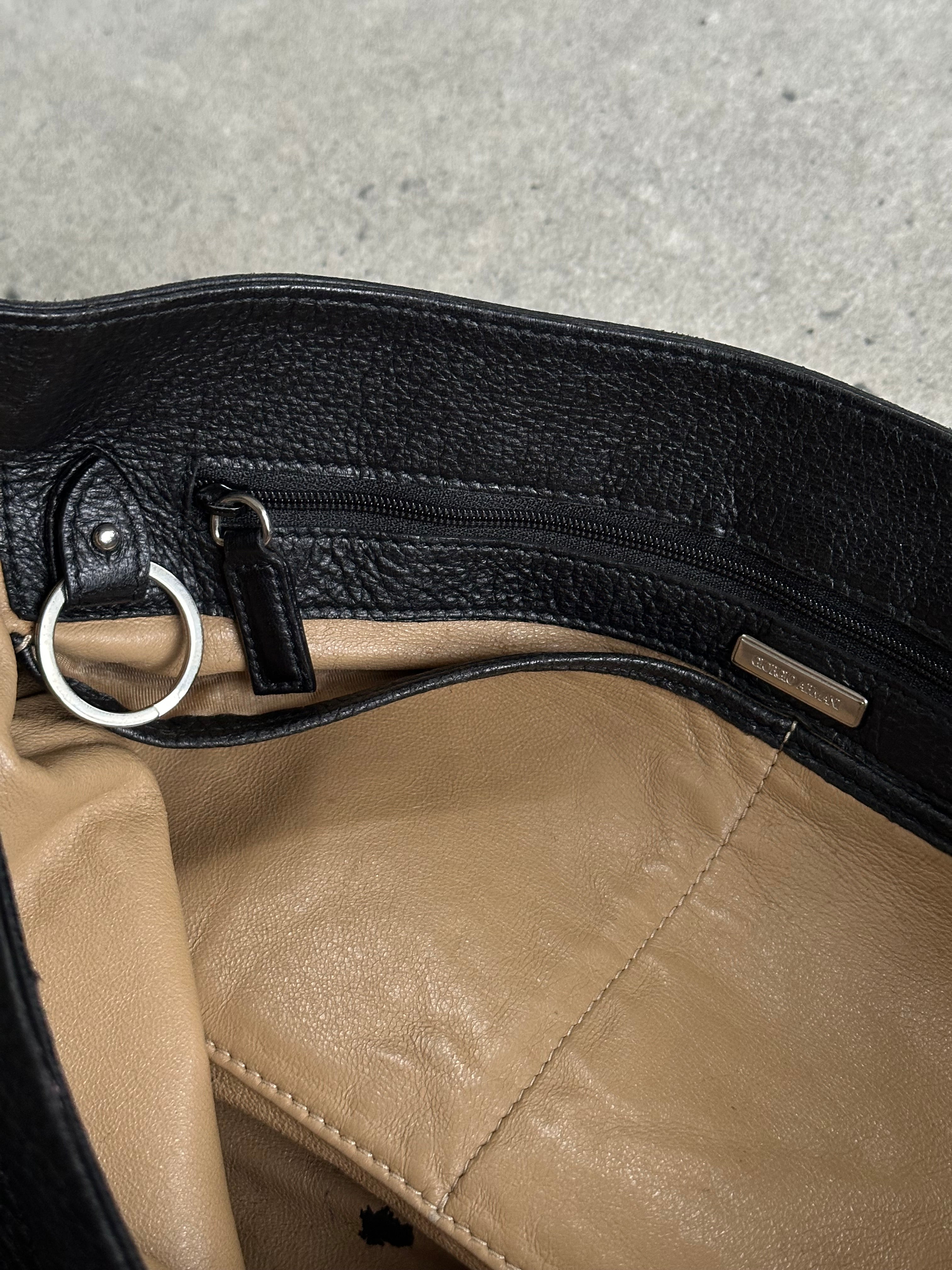 Giorgio Armani leather crossbody bag from the 2000s with sleek design and adjustable strap, featuring a classic black finish.
