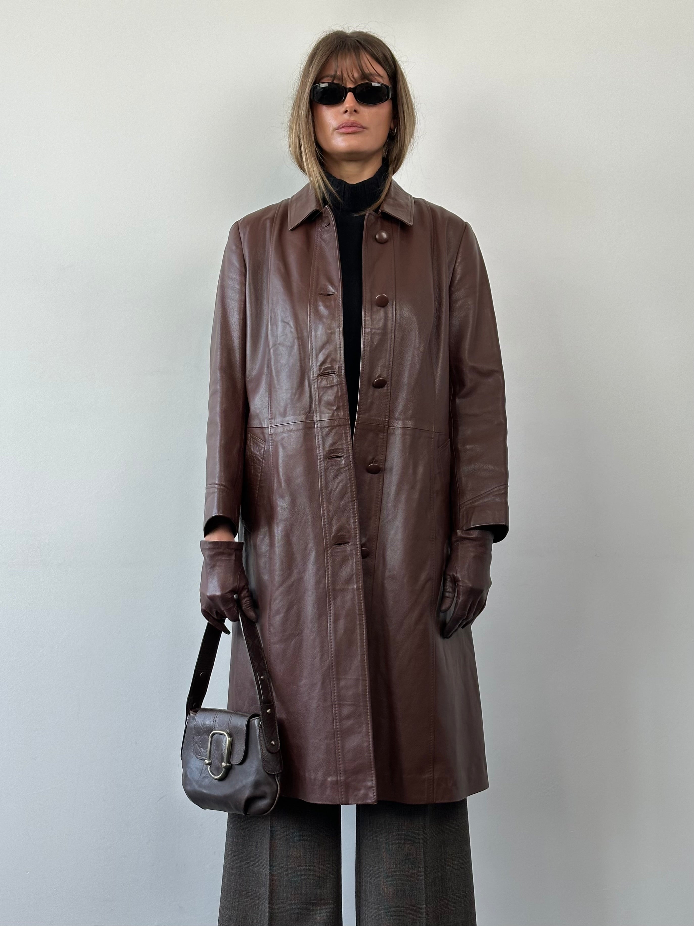 Vintage smooth leather belted trench coat jacket in classic style, featuring a waist belt and button details.