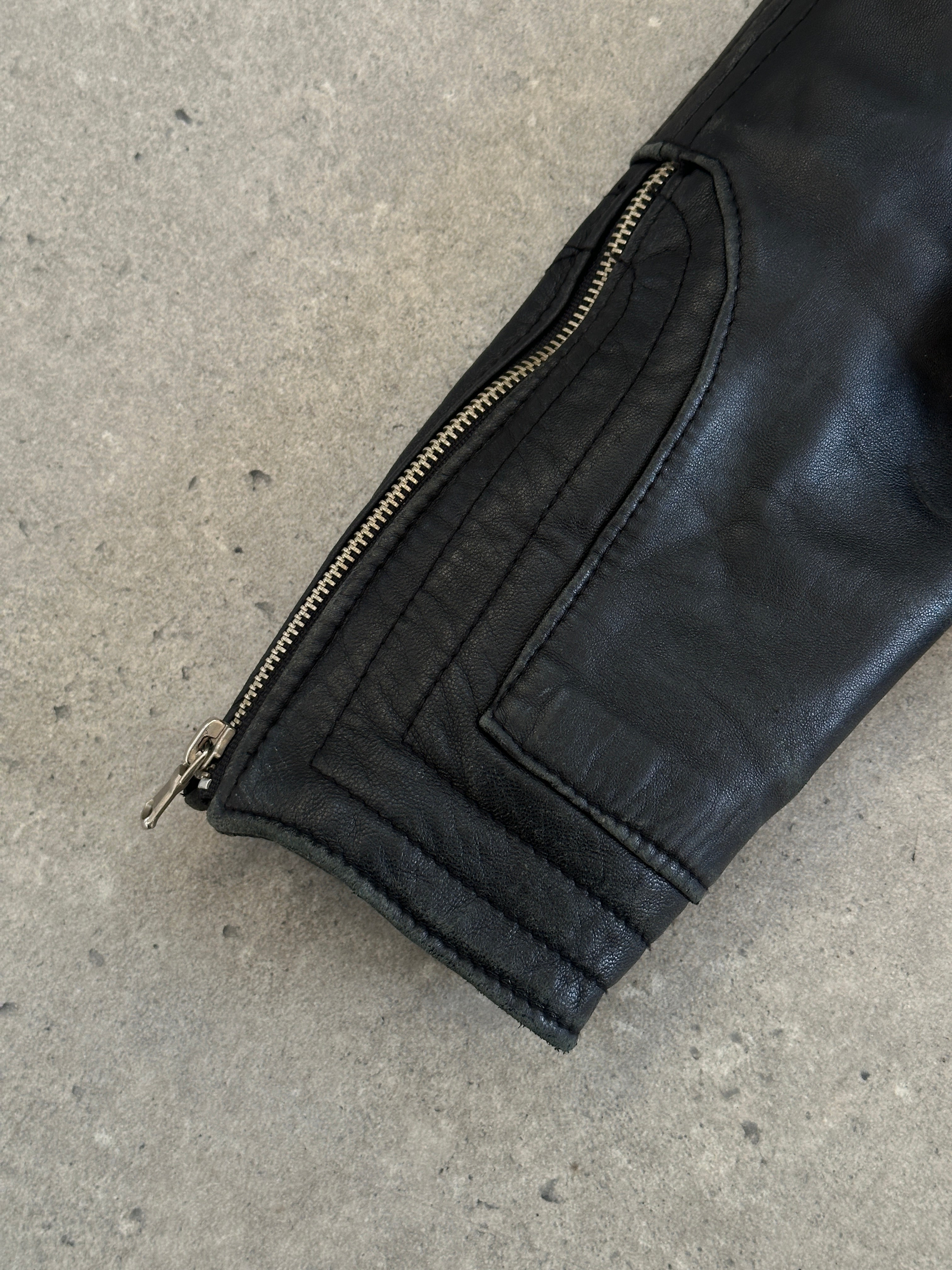 Vintage Italian 1990s fitted leather jacket with buckled details, showcasing classic style and rich brown leather.