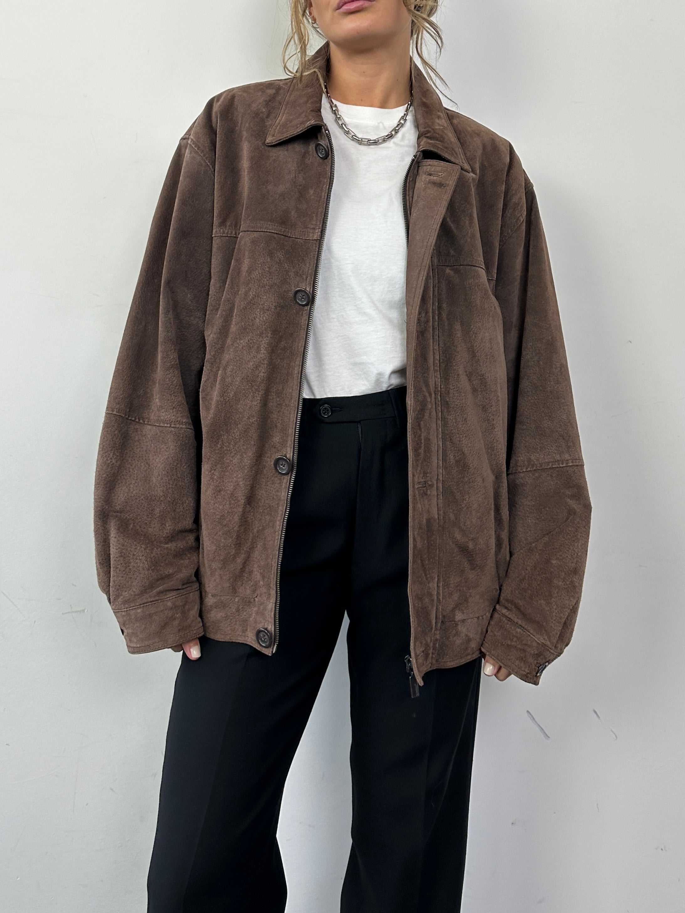 Vintage suede leather bomber jacket in size L, showcasing classic design with a smooth tan finish and ribbed collar and cuffs.