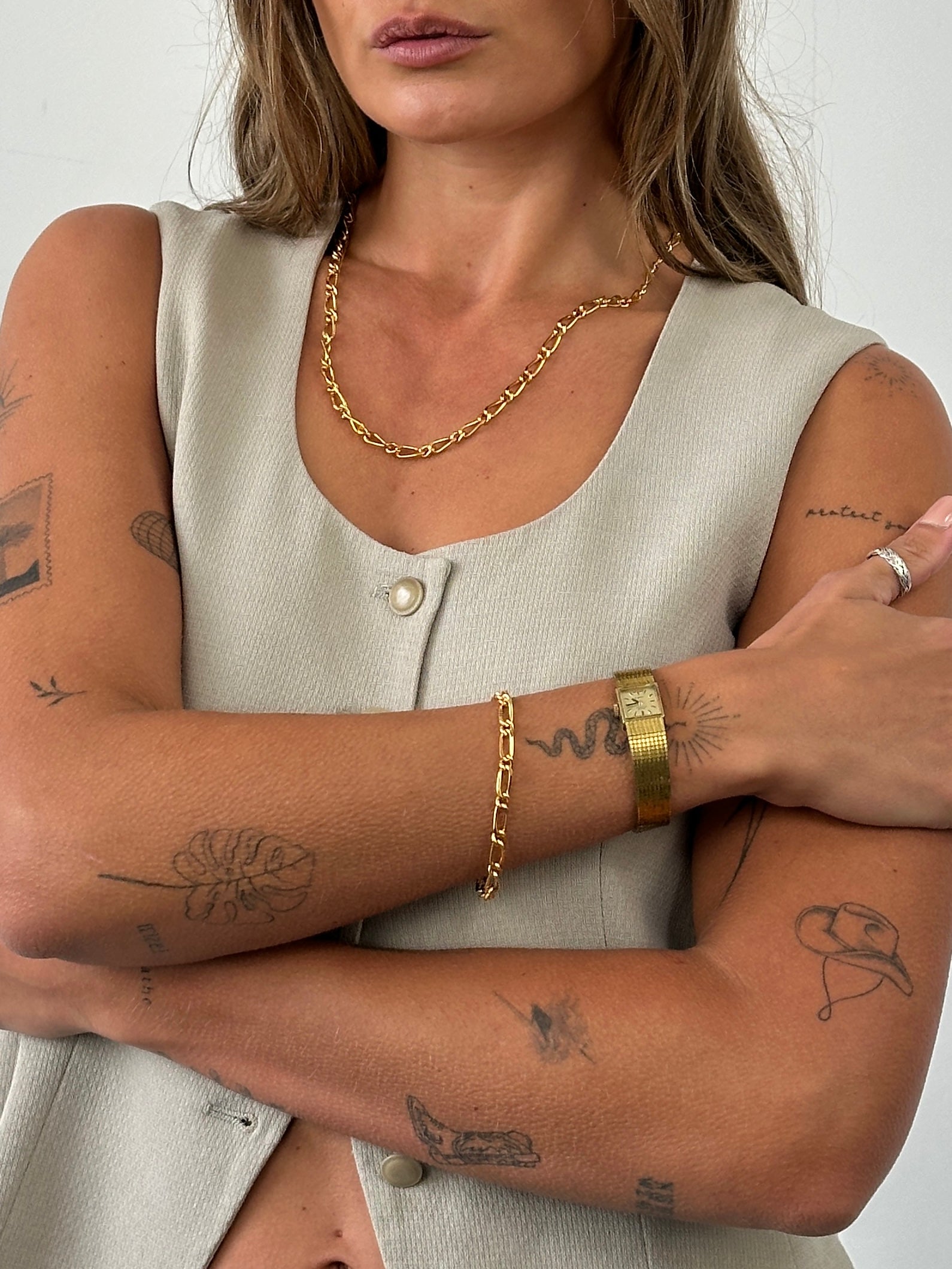 Pierre Cardin gold-plated necklace and bracelet chain set with sleek, polished links, showcasing elegant jewelry design.