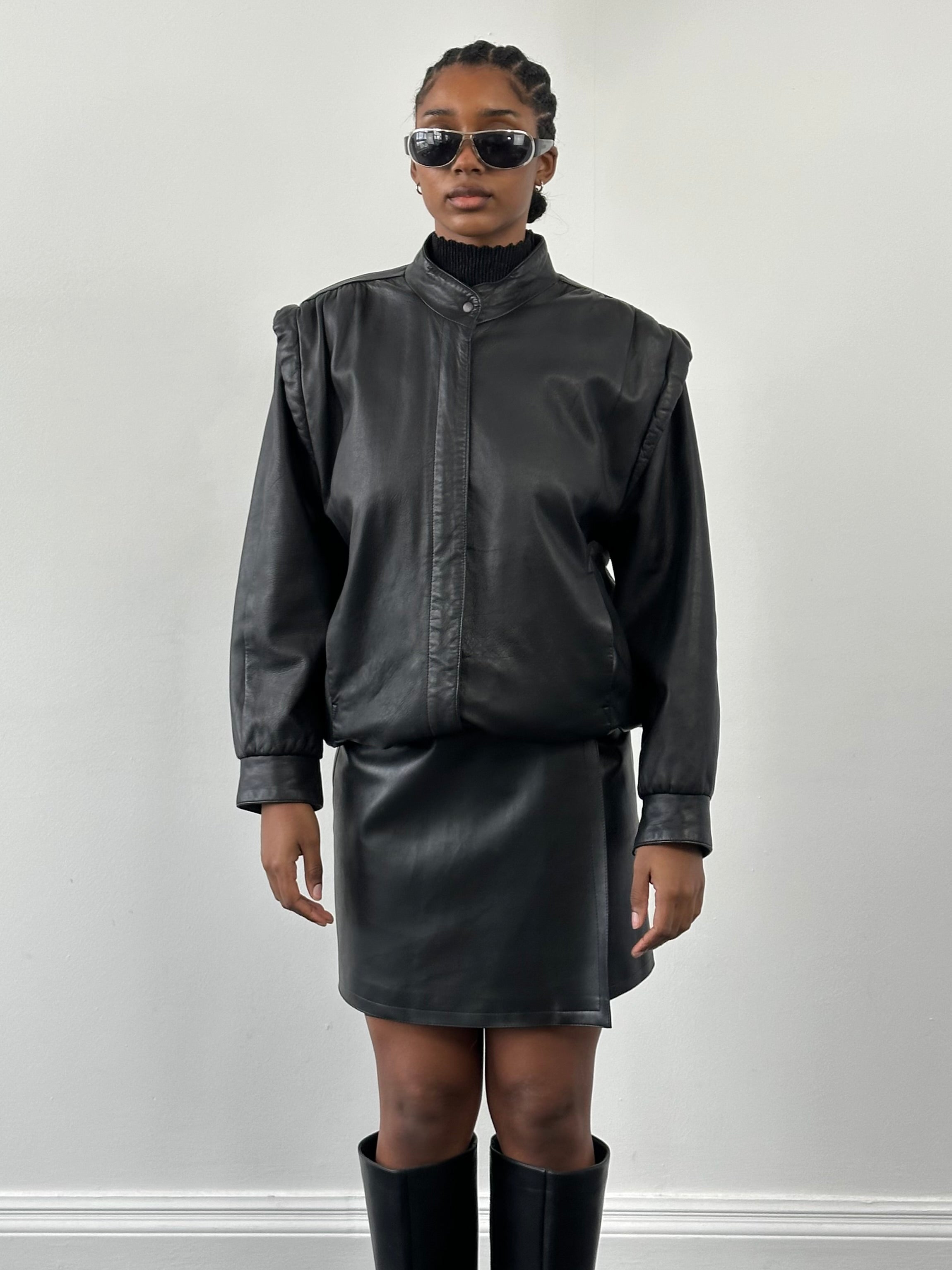 Vintage faux leather wrap mini skirt with high waist and stylish design, shown on a model.
