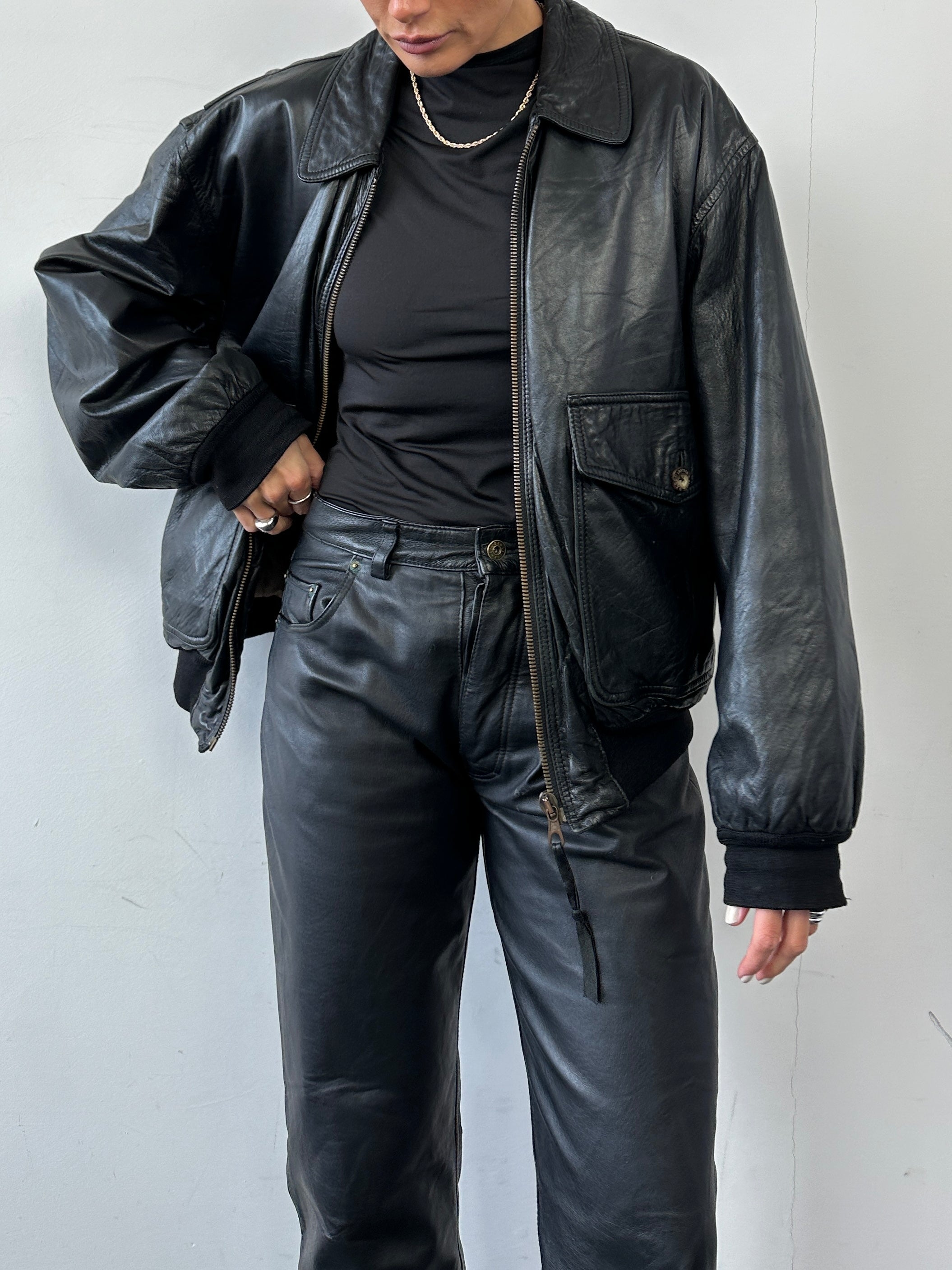 Vintage leather bomber jacket in size large, featuring a classic design with ribbed cuffs and collar, made by Vintage brand.
