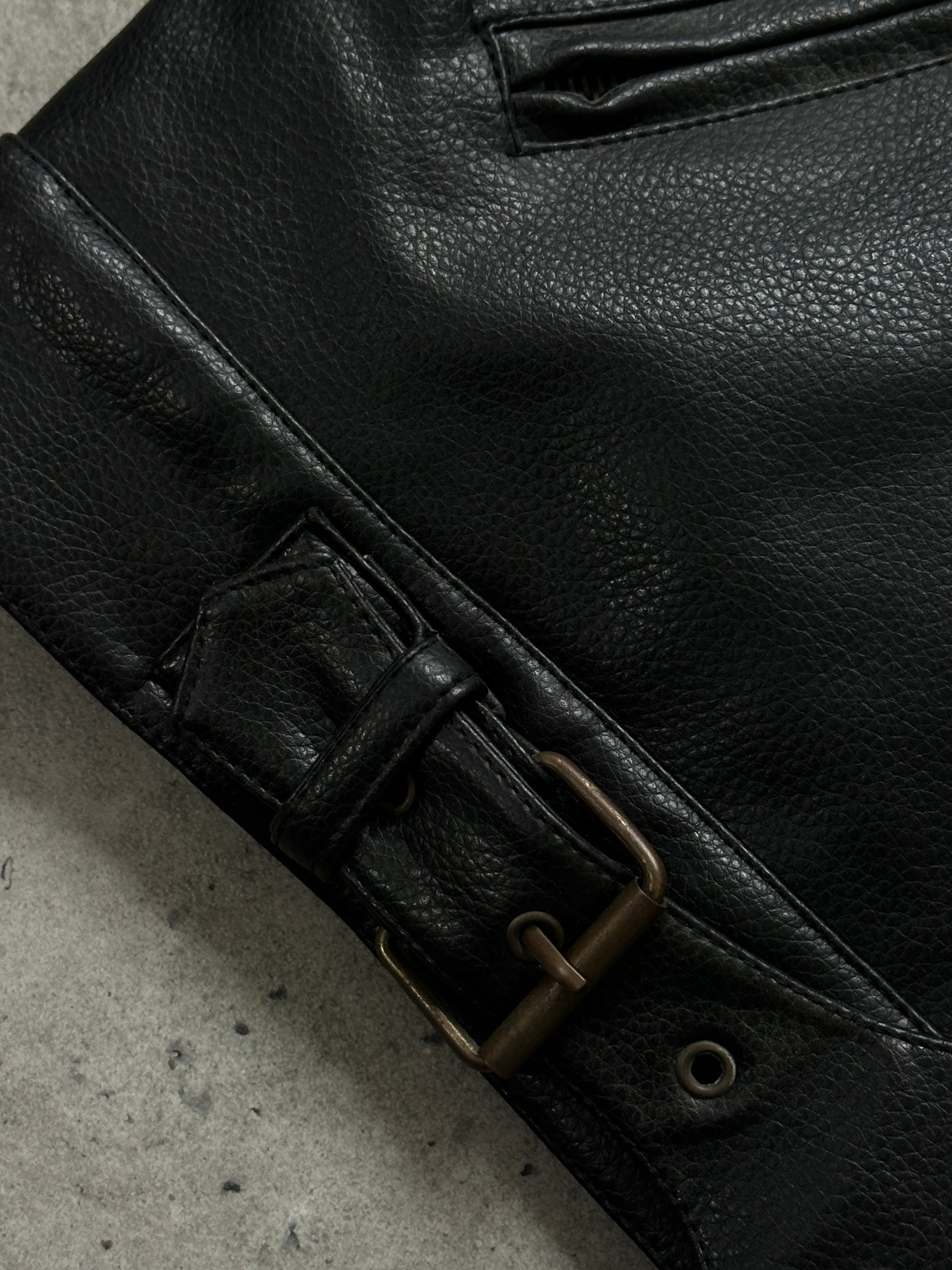Vintage 1990s boxy faux leather jacket in size M, featuring a classic design with a structured fit and textured black faux leather.