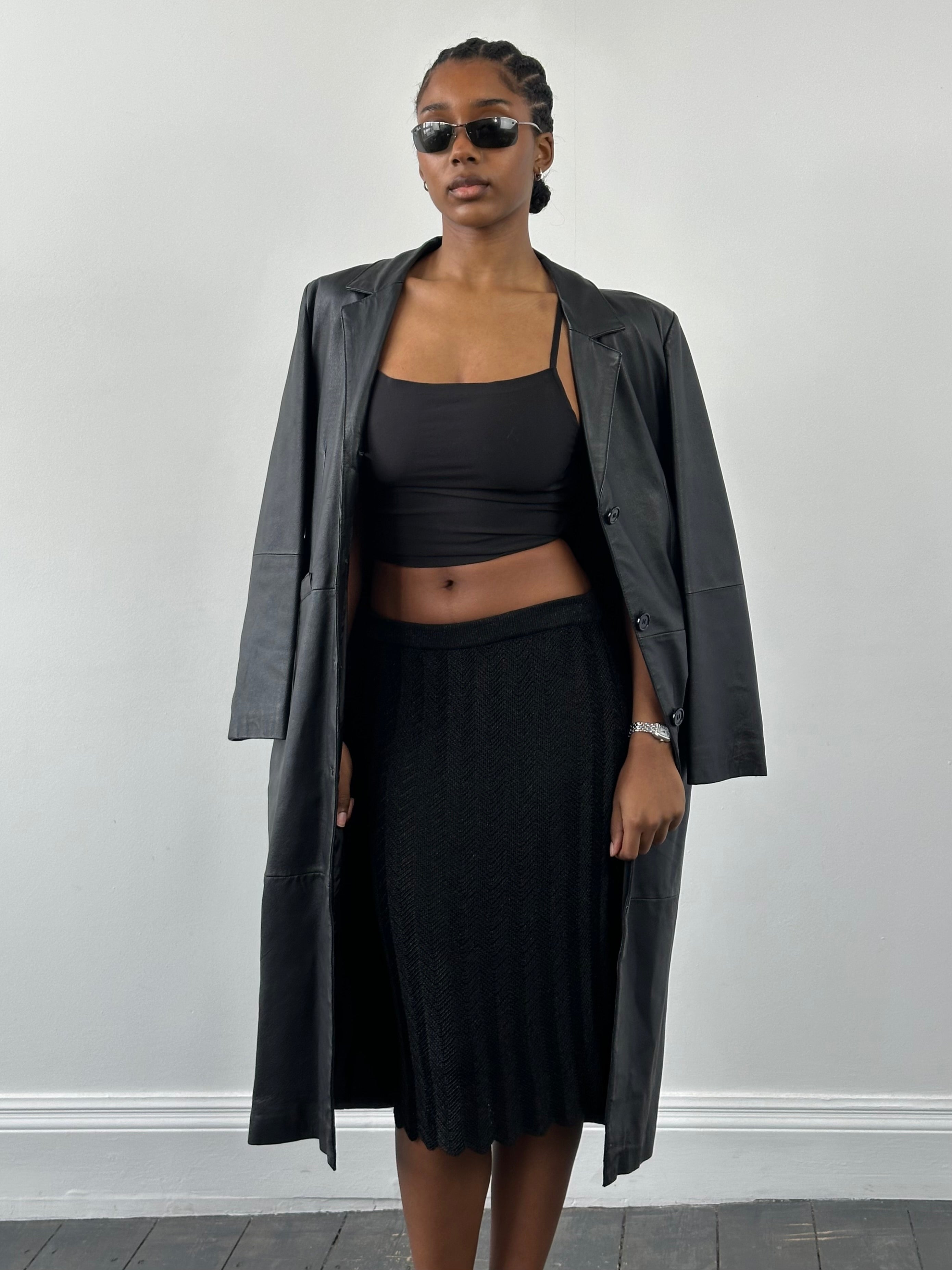 Vintage 1990s knit mini skirt in various sizes, featuring a classic retro design and textured fabric.