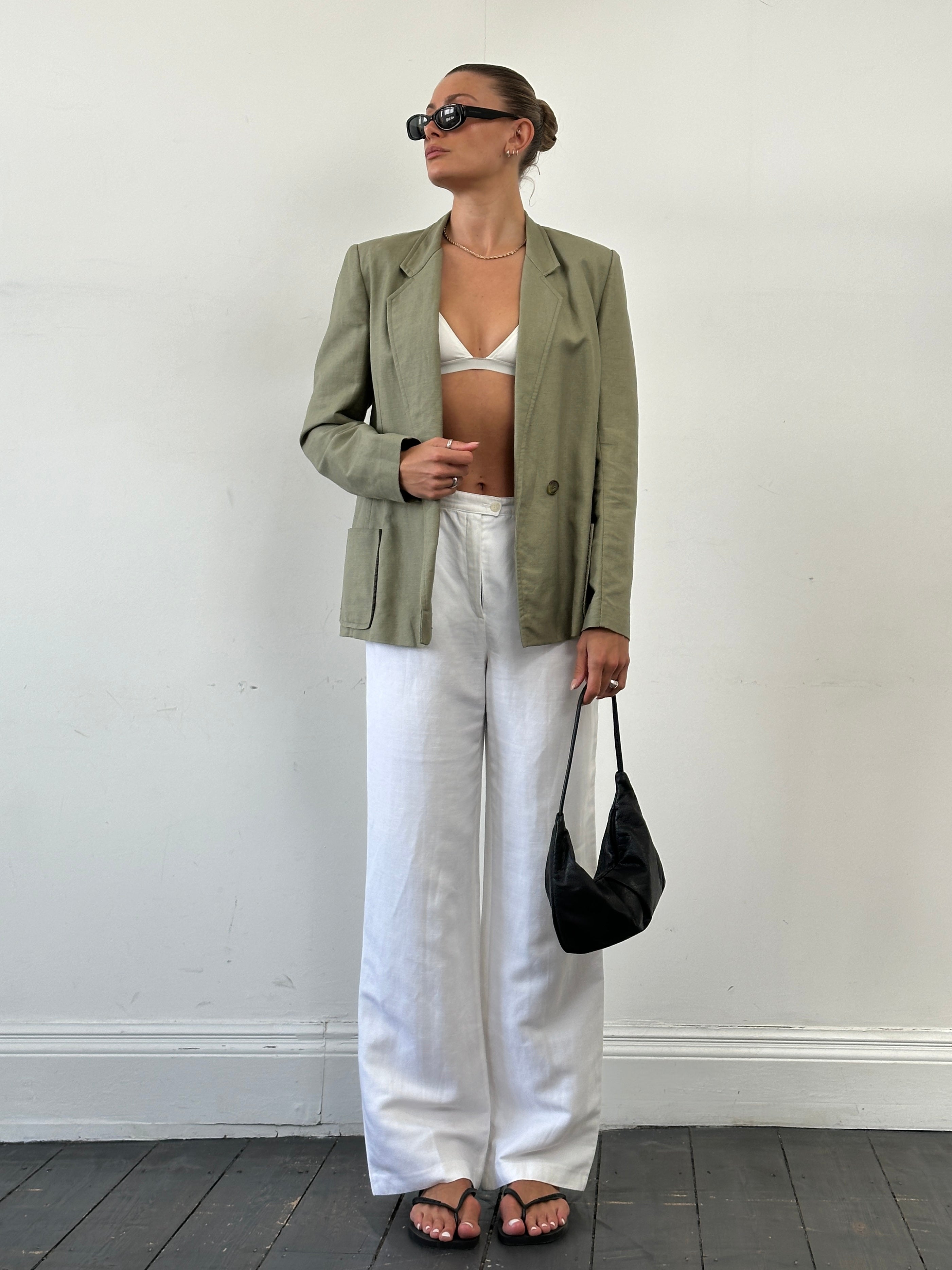 Vintage linen double-breasted blazer in size M, featuring classic tailored design and neutral color, displayed on a hanger.