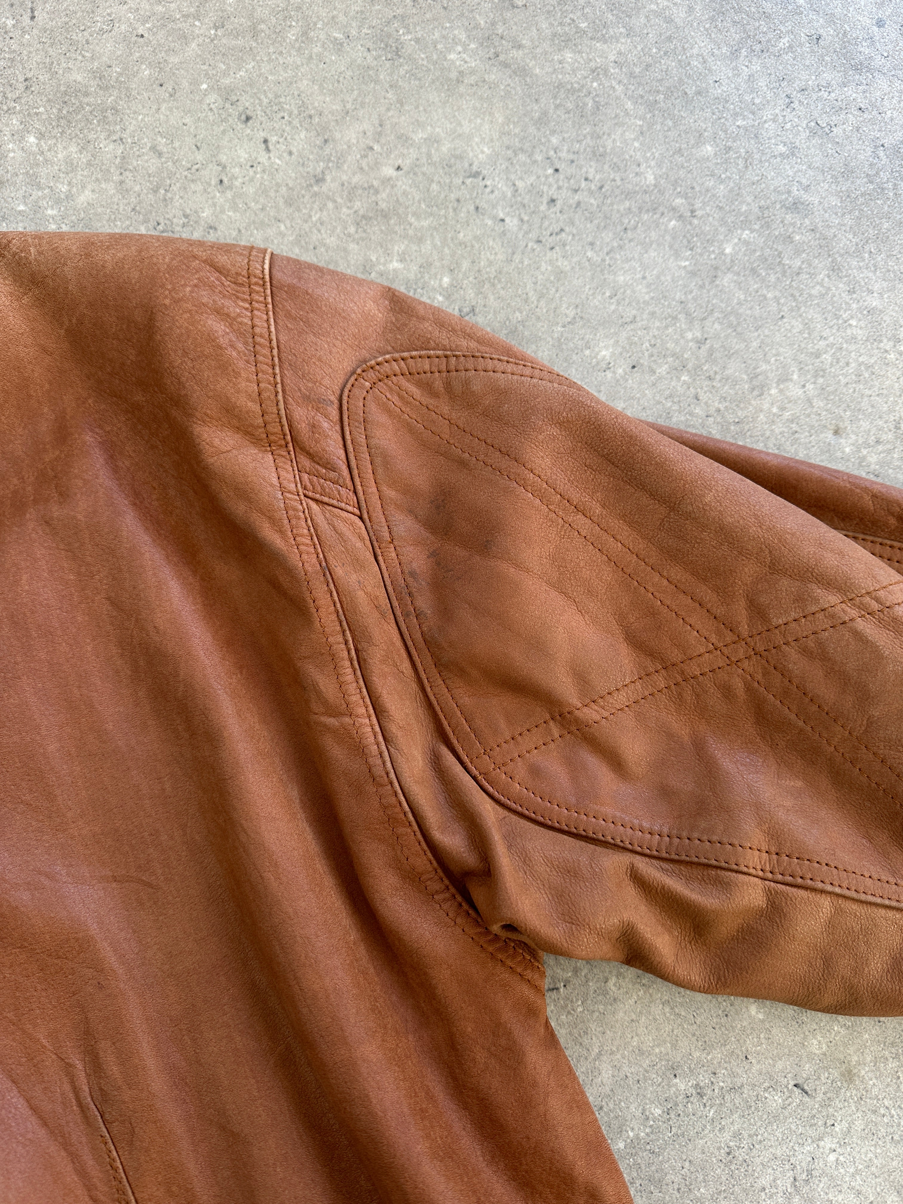 Vintage 1980s leather bomber jacket in size large, featuring classic design with ribbed cuffs and collar, made by Vintage.
