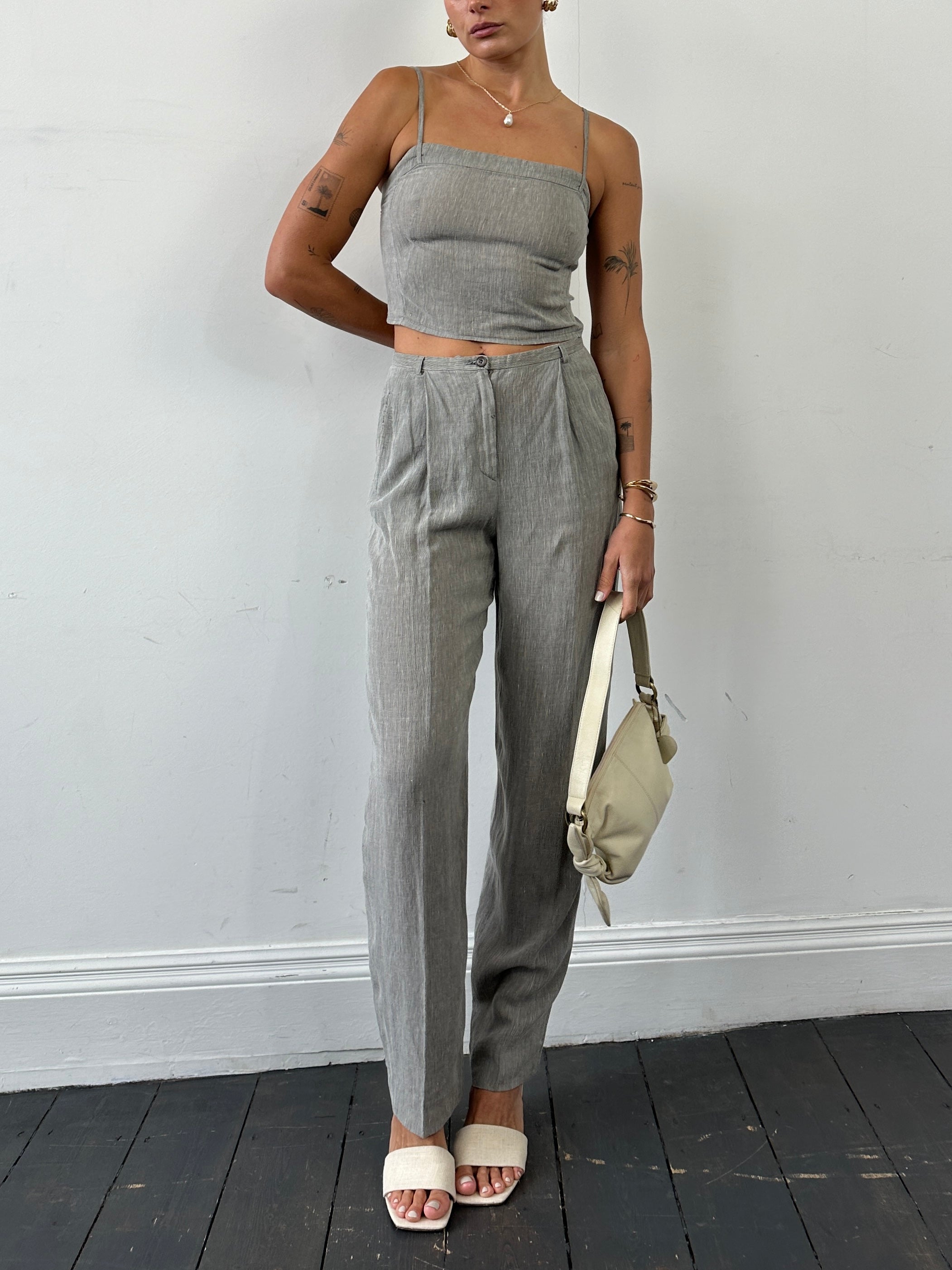 Mani Linen two-piece top and trouser co-ord set in soft beige, featuring relaxed fit trousers and a matching sleeveless top.