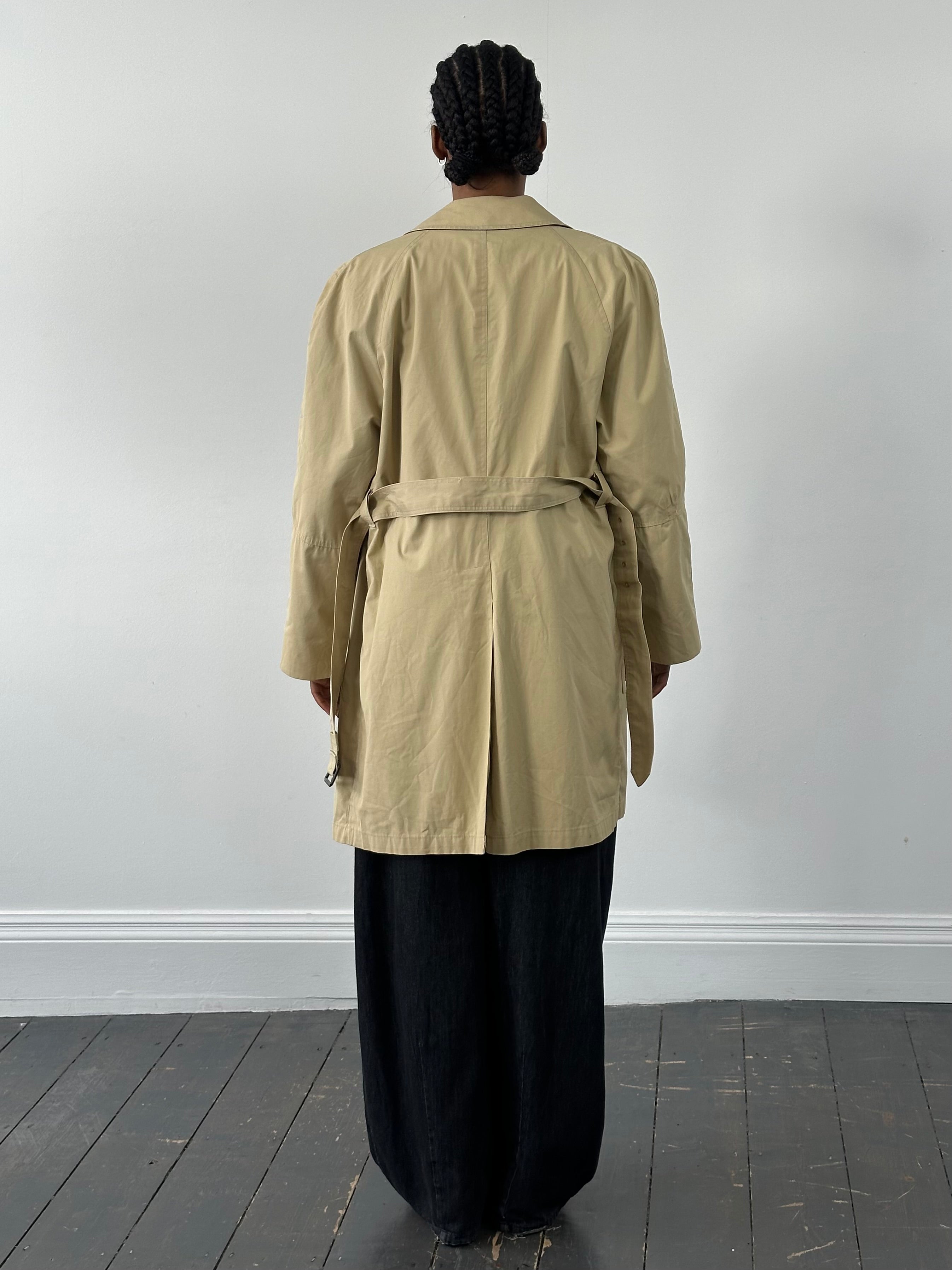 Christian Dior Paris 1980s cotton belted trench coat, beige color, tailored fit, with classic collar and button details.