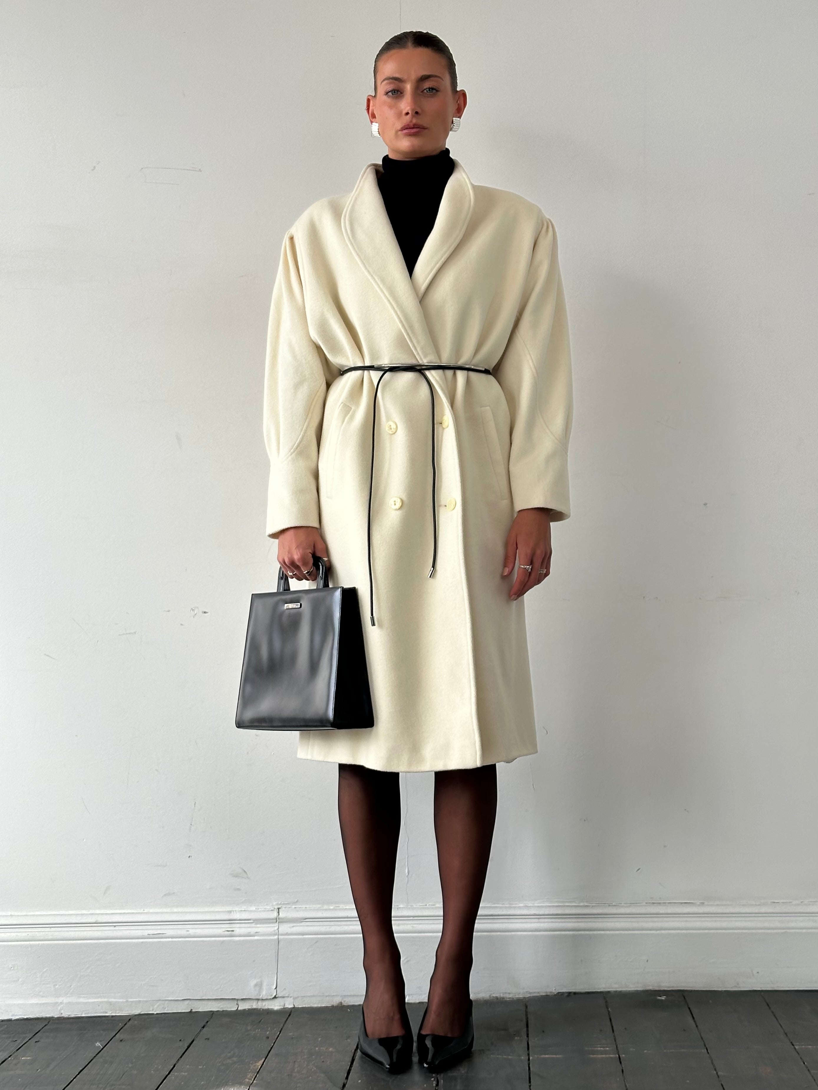 Vintage pure wool double-breasted coat in size L/XL, featuring classic style and tailored fit, shown on a hanger.