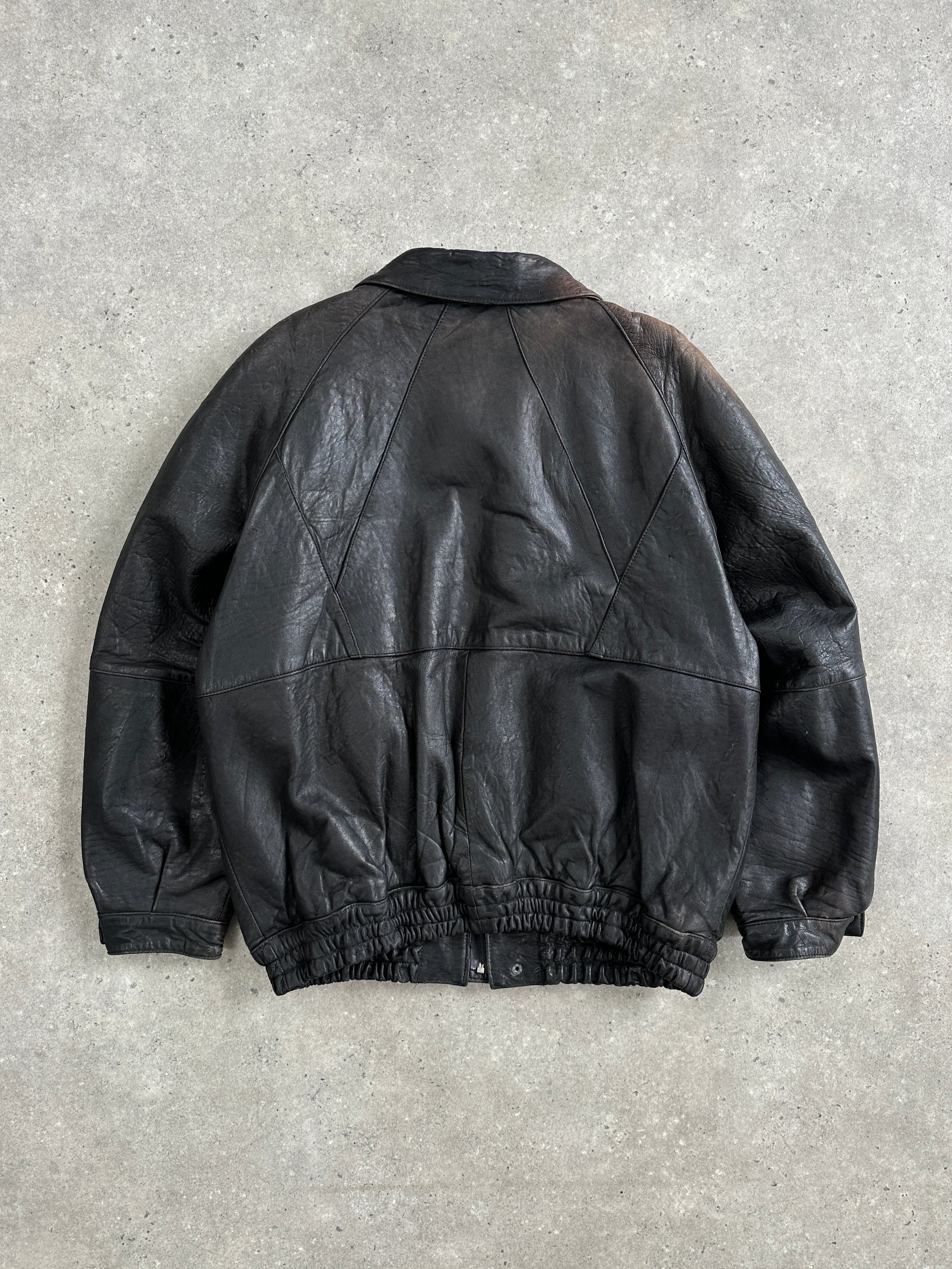Vintage 1980s aged leather bomber jacket in XL size, featuring classic style and distressed leather texture.