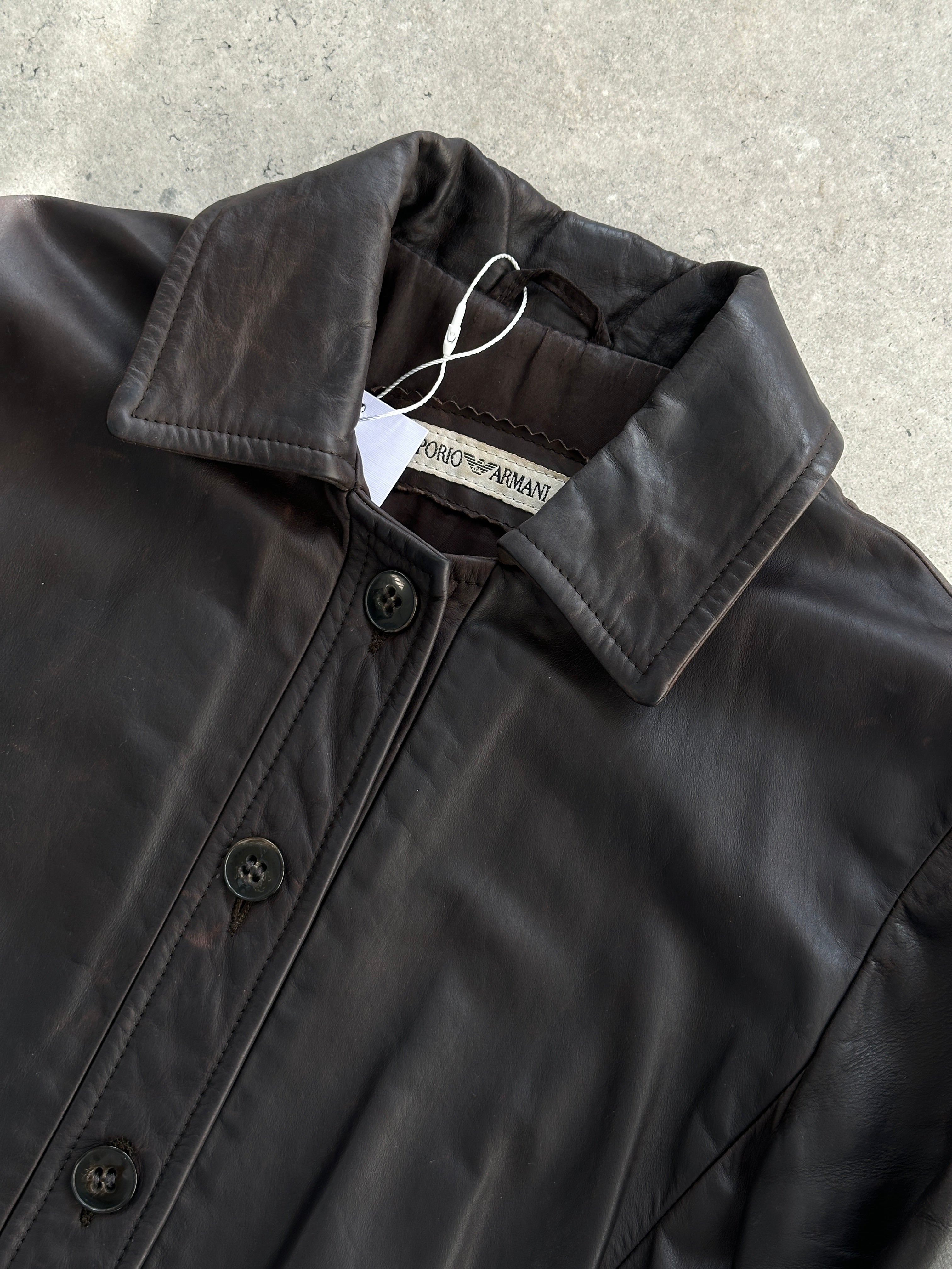 Emporio Armani leather jacket in size S, featuring classic design and high-quality black leather, displayed on a hanger.