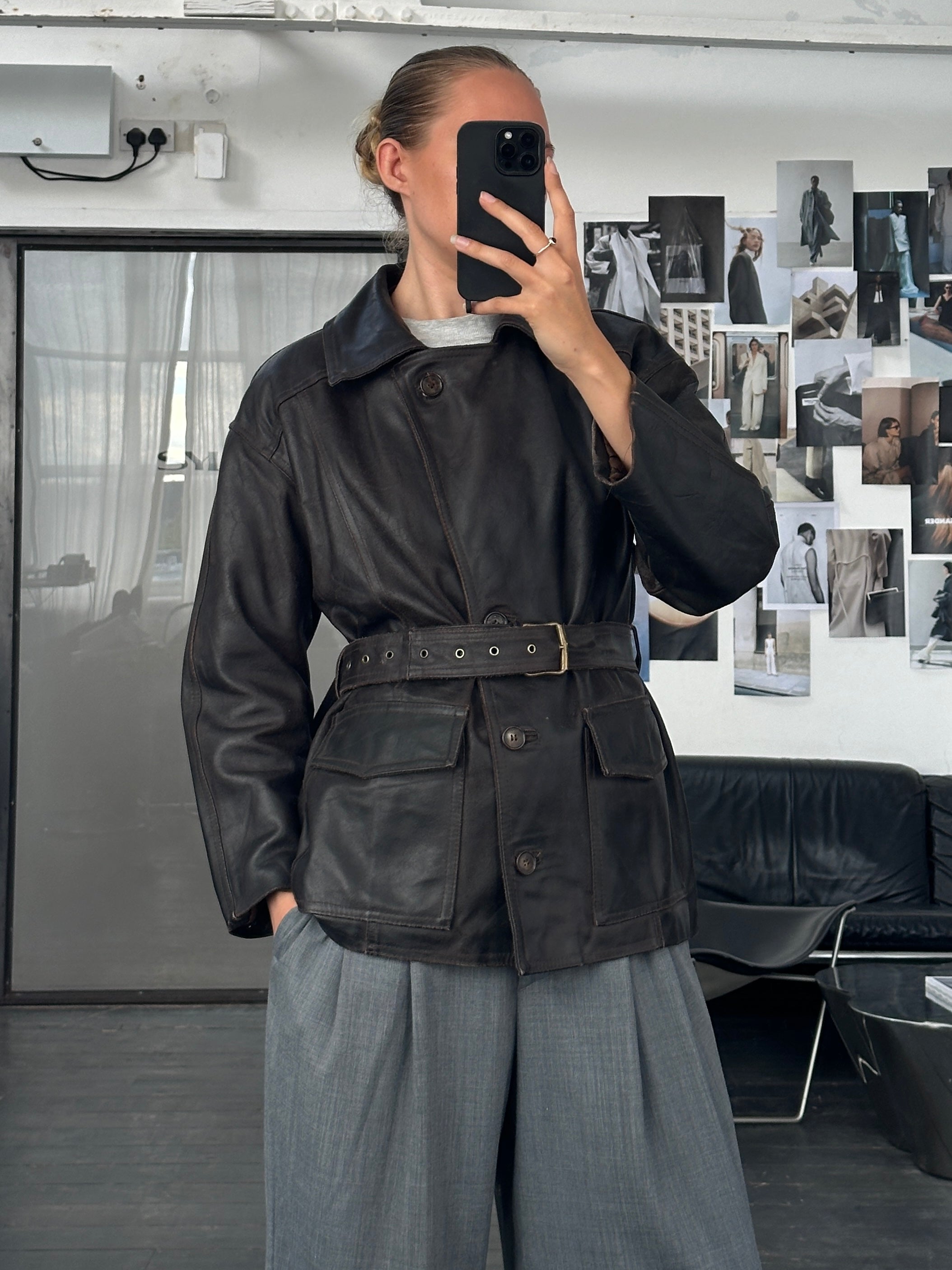 Vintage Italian 1980s belted leather jacket, medium size, featuring classic design and aged leather texture.