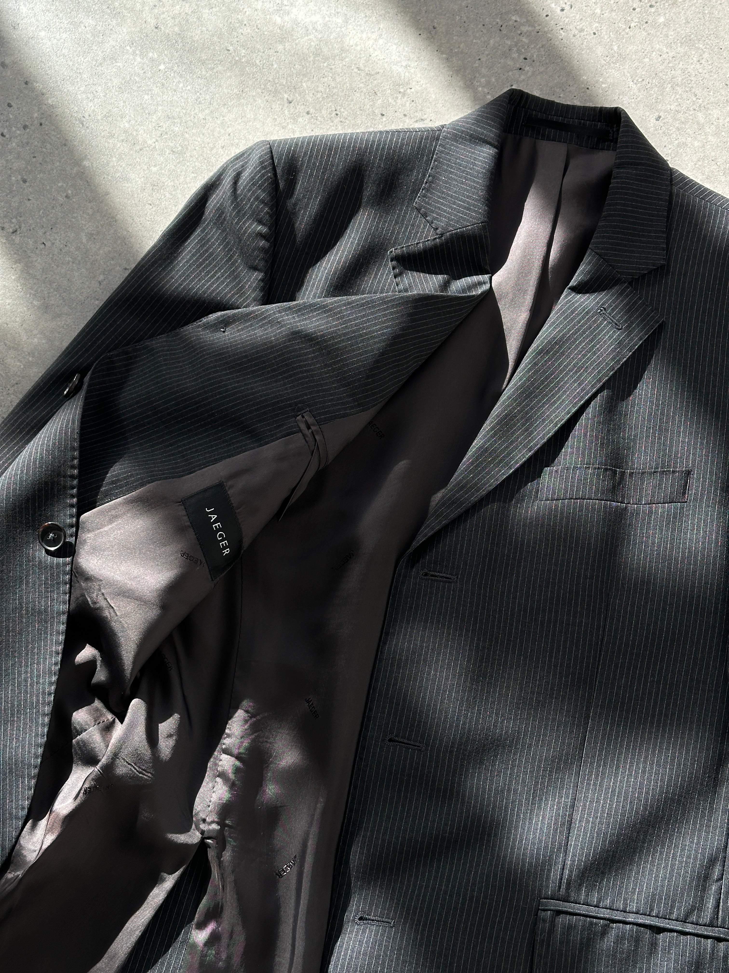 Jaeger pure wool pinstripe blazer in size 40R/M, tailored fit with classic pinstripe pattern and structured lapel, front button closure.