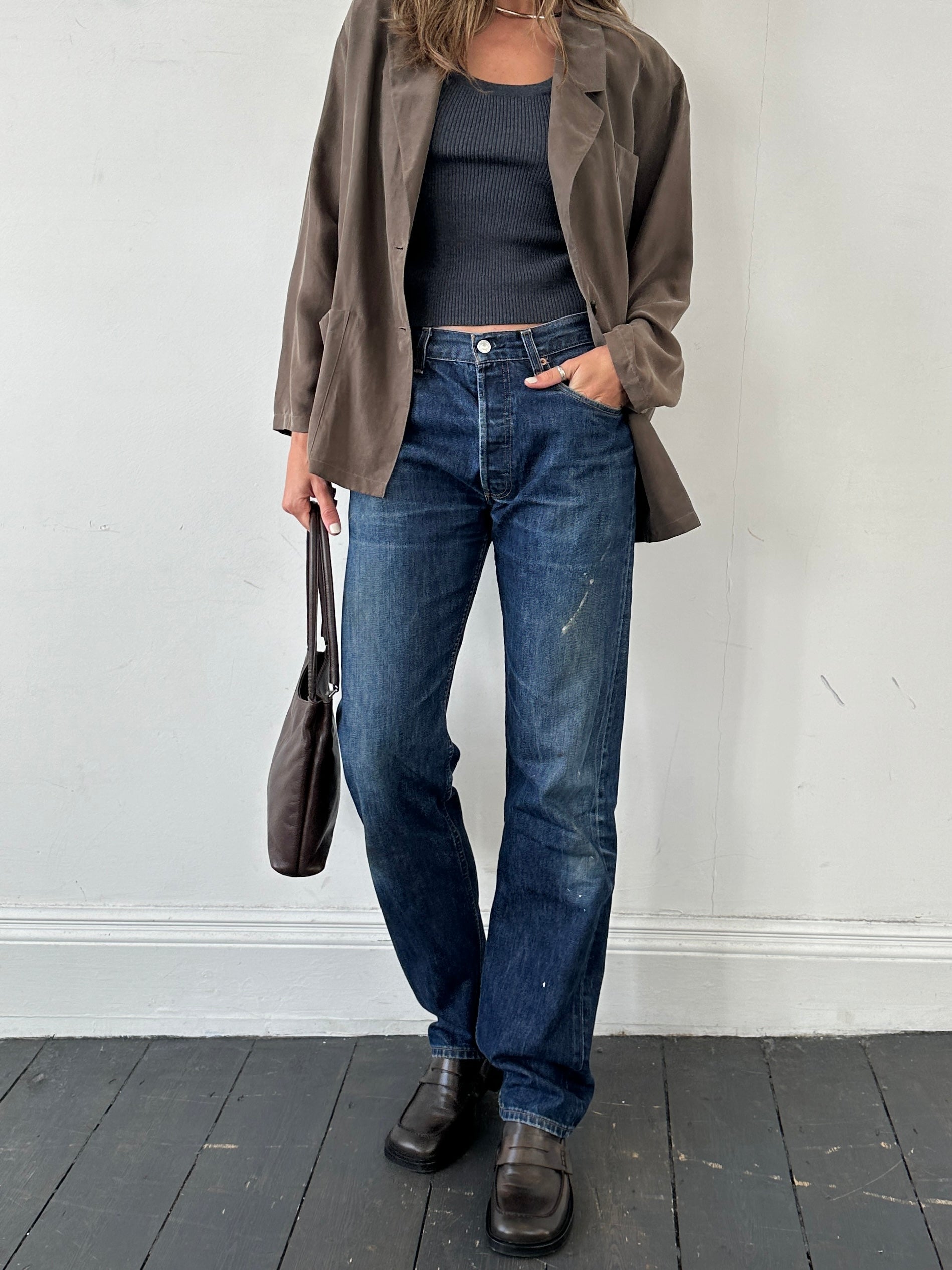 Levi’s 501 distressed straight leg denim jeans in W30, showing a close-up of the faded, torn details and classic fit.