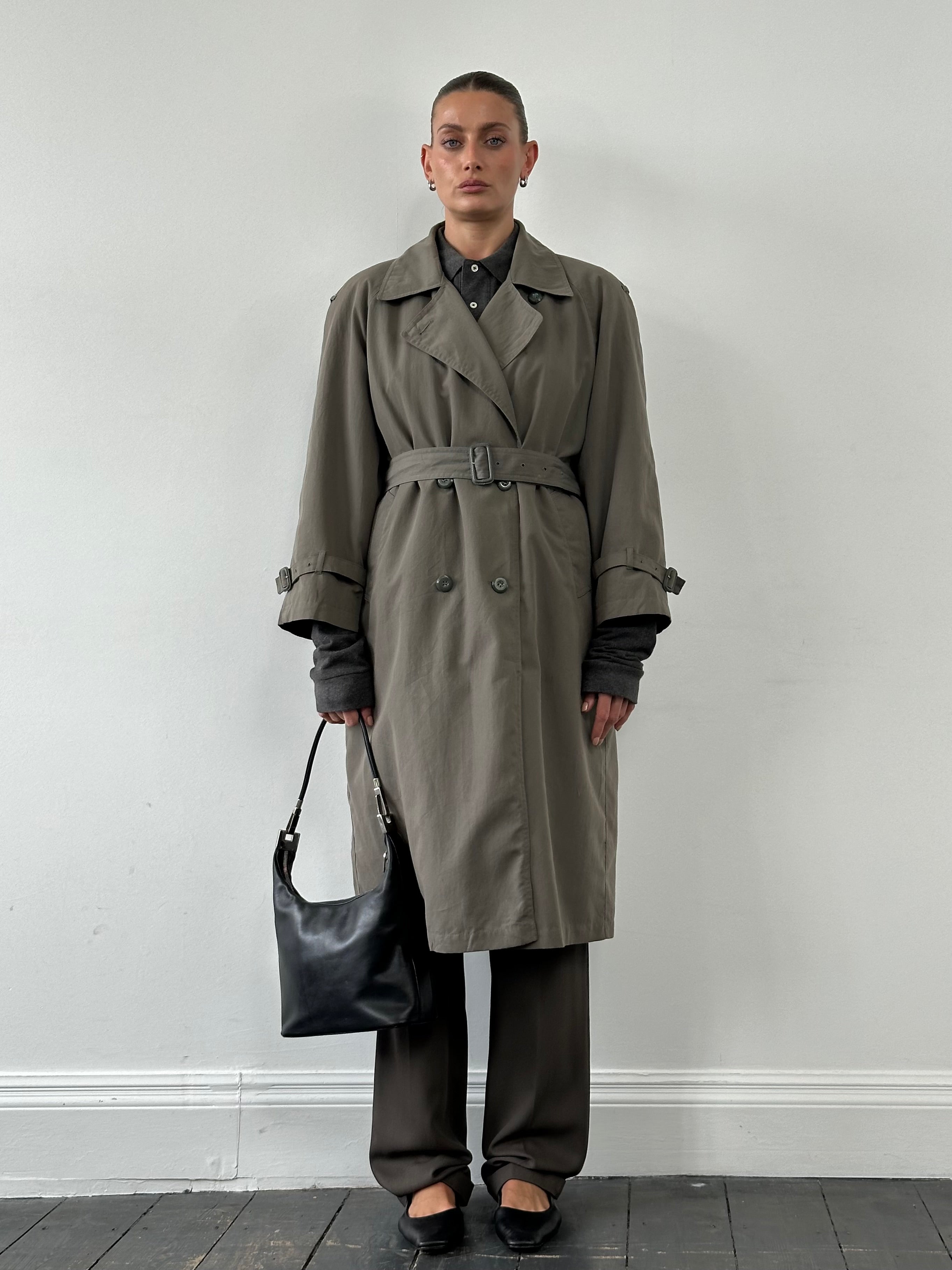 London Fog double-breasted trench coat in S/M, classic beige color, tailored fit, with belt and button details.