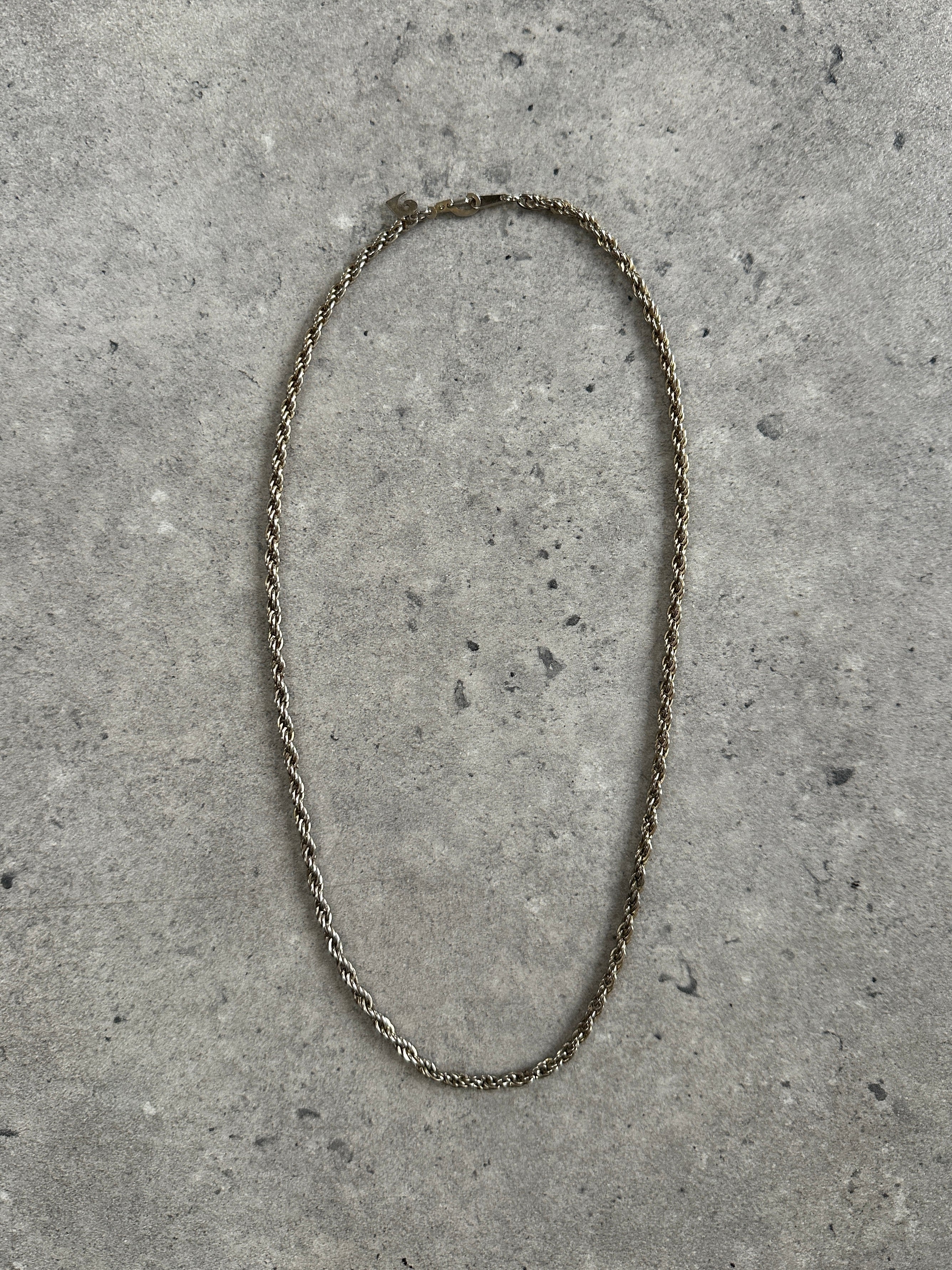 Pierre Cardin 1990s gold plated rope necklace, 18-inch length, showcasing shiny, twisted metal design on a neutral background.