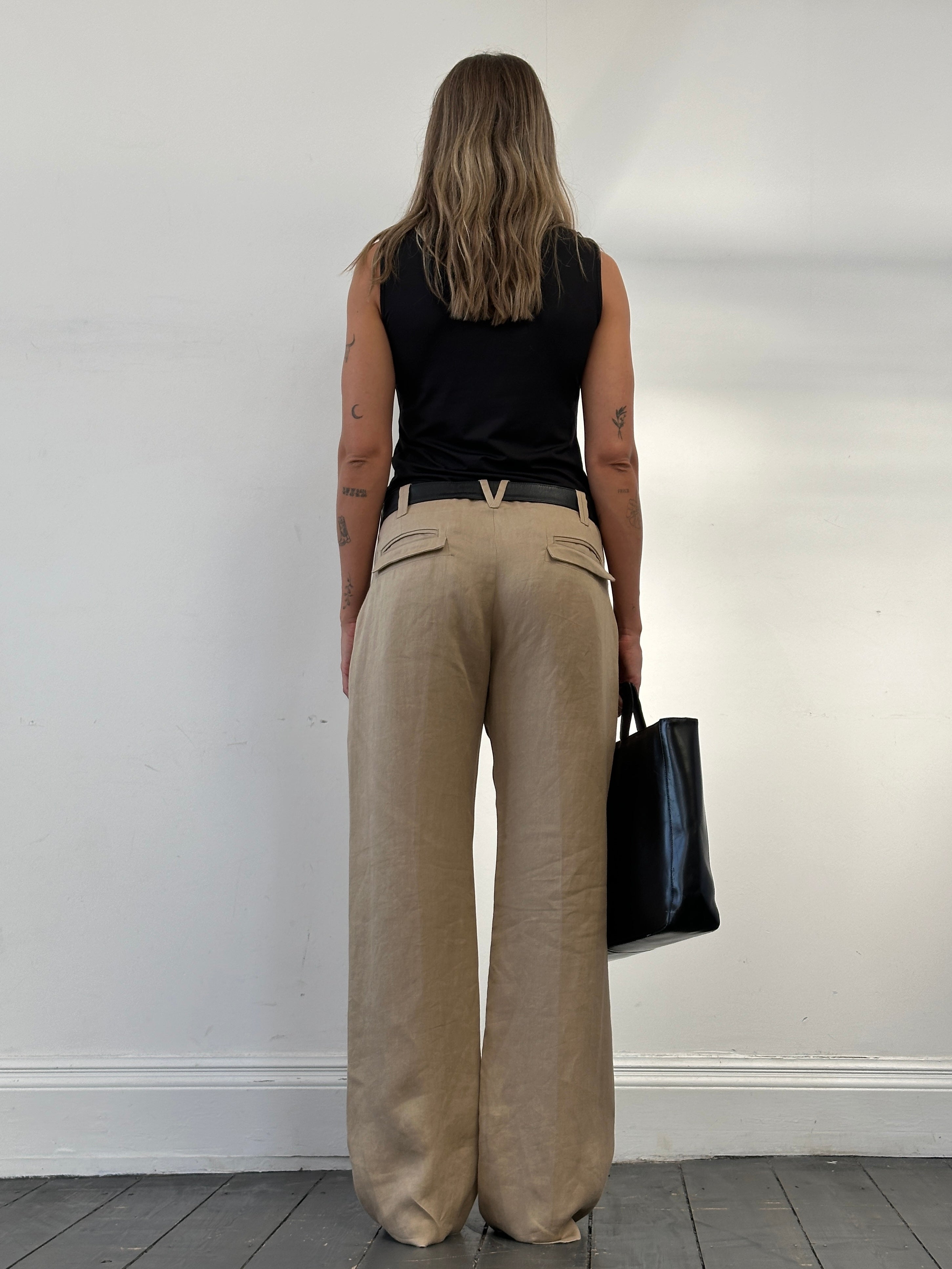 Versace 1990s pure ramie wide-leg trousers in size W34, beige fabric with a relaxed fit and front pleats.