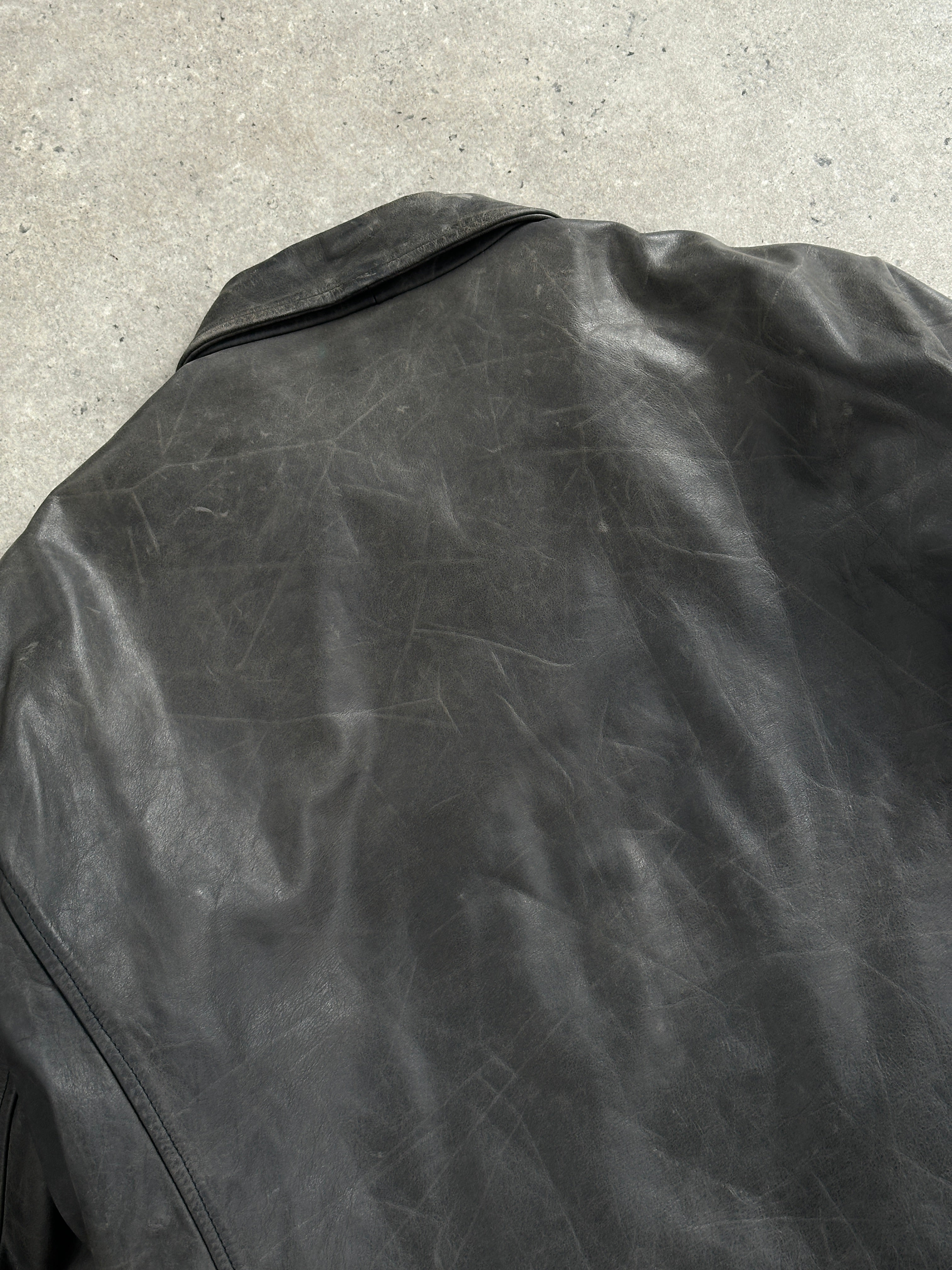 Vintage 1990s boxy leather jacket in aged brown leather, with wide lapels and vintage detailing, size L/XL.