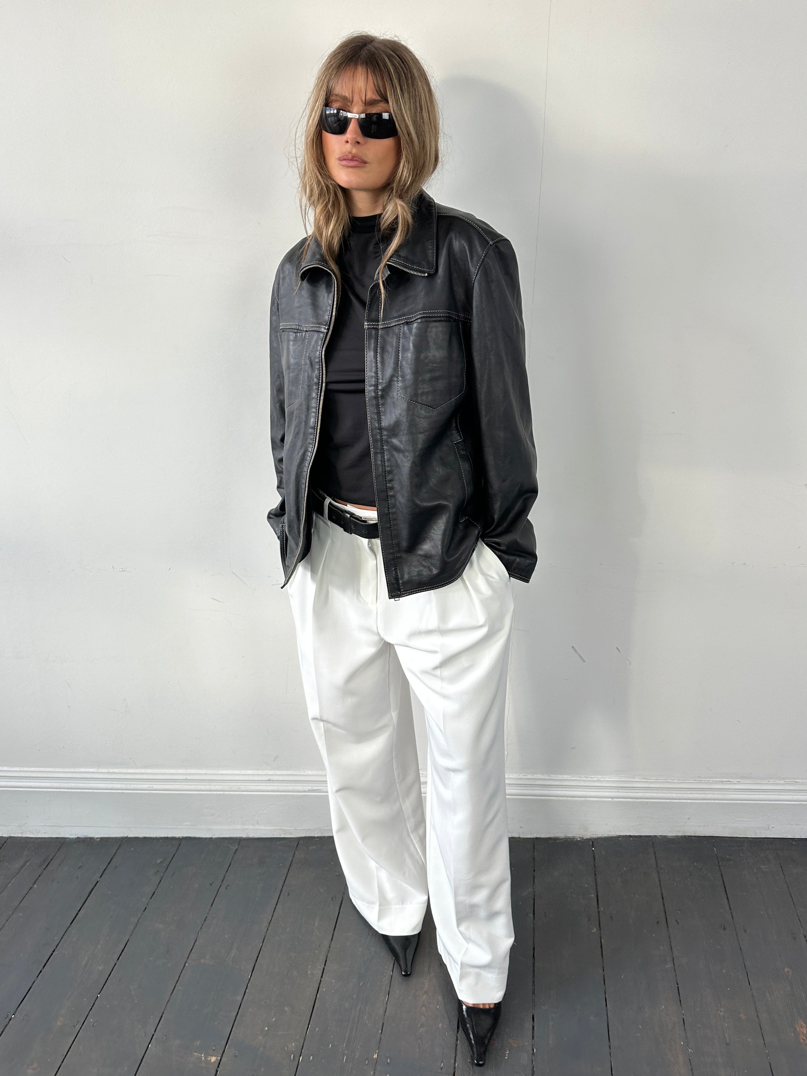 Vintage contrast stitch leather jacket in size M, featuring classic design and detailed stitching on the front and sleeves.