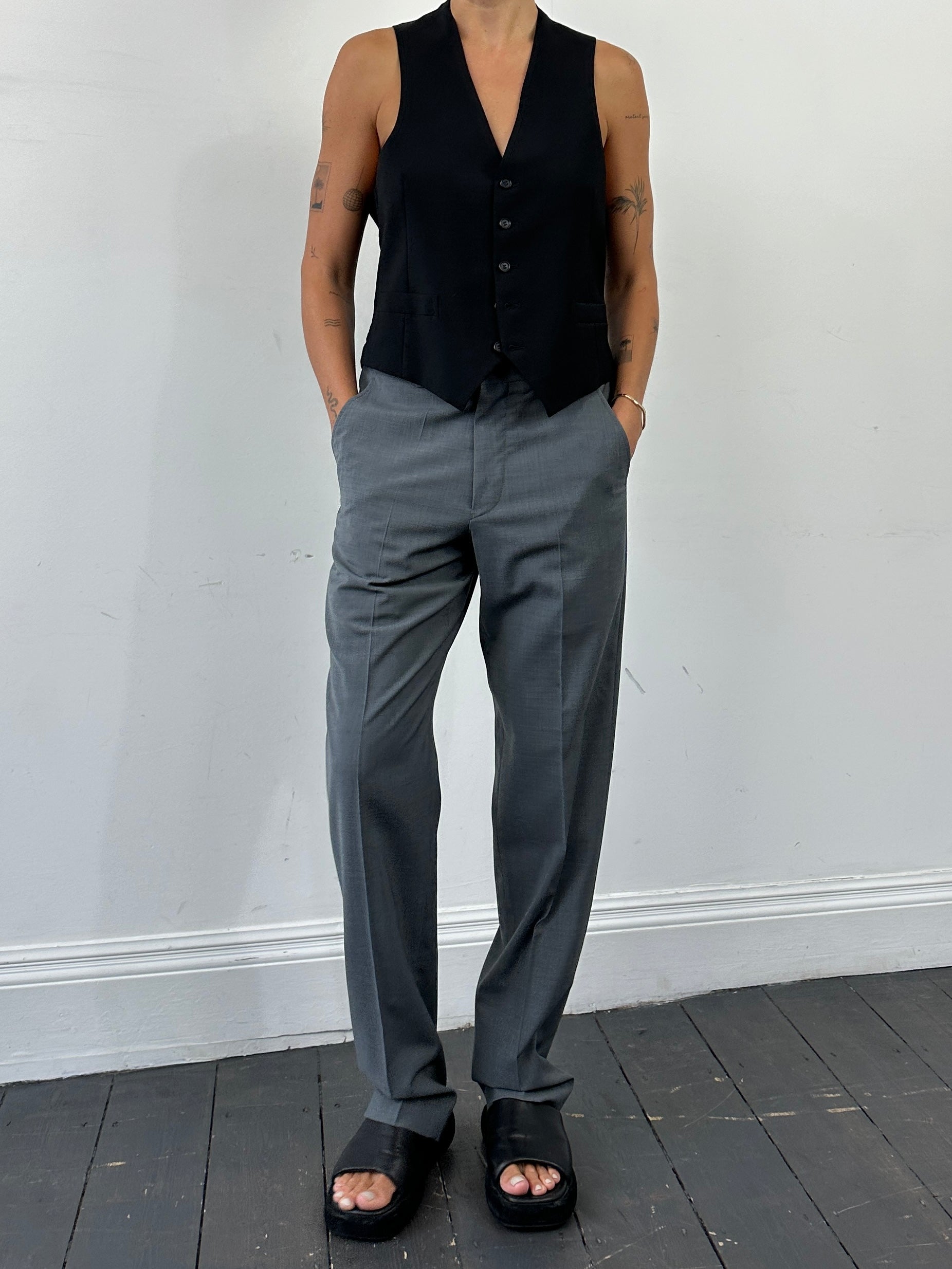 Emporio Armani tailored high-waisted wool trousers in dark fabric, front view showing clean lines and classic style.