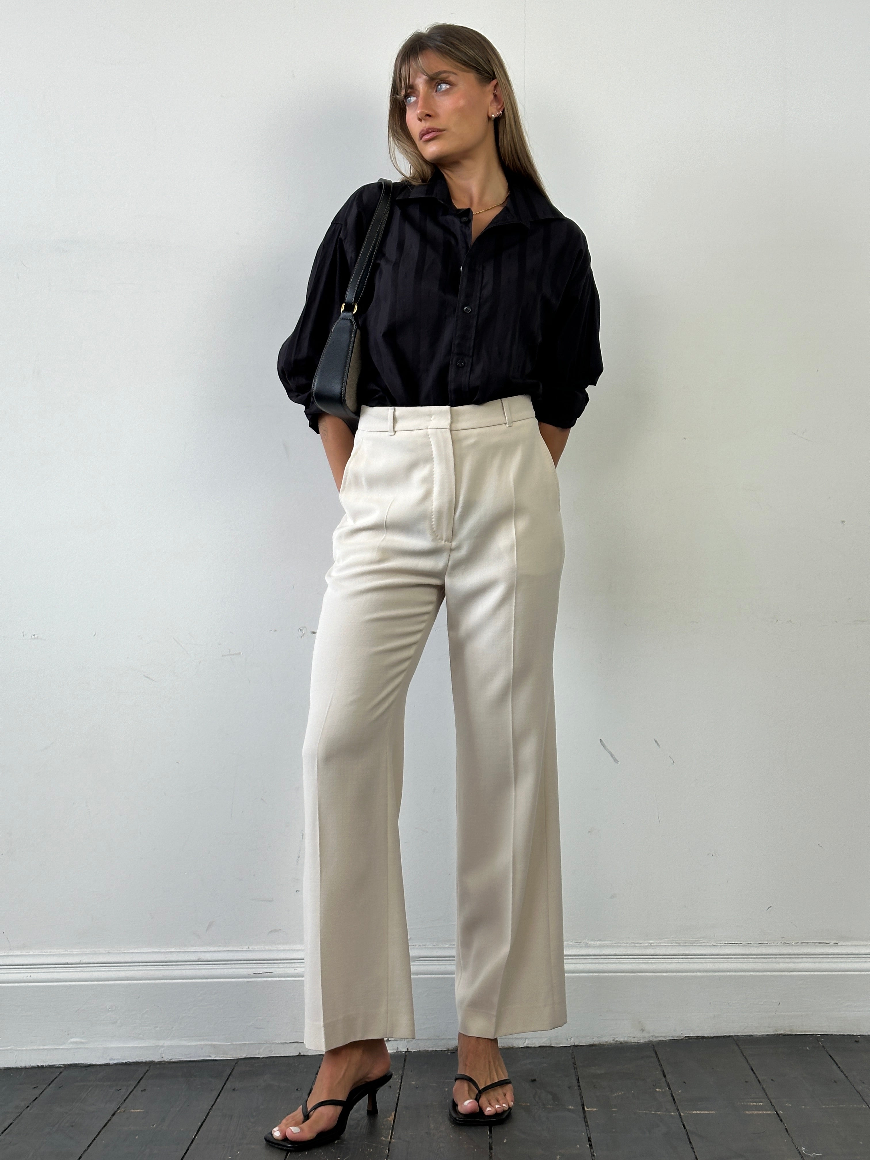 Max Mara high-waisted tailored wool trousers in neutral color, featuring a sleek, structured fit and classic design.