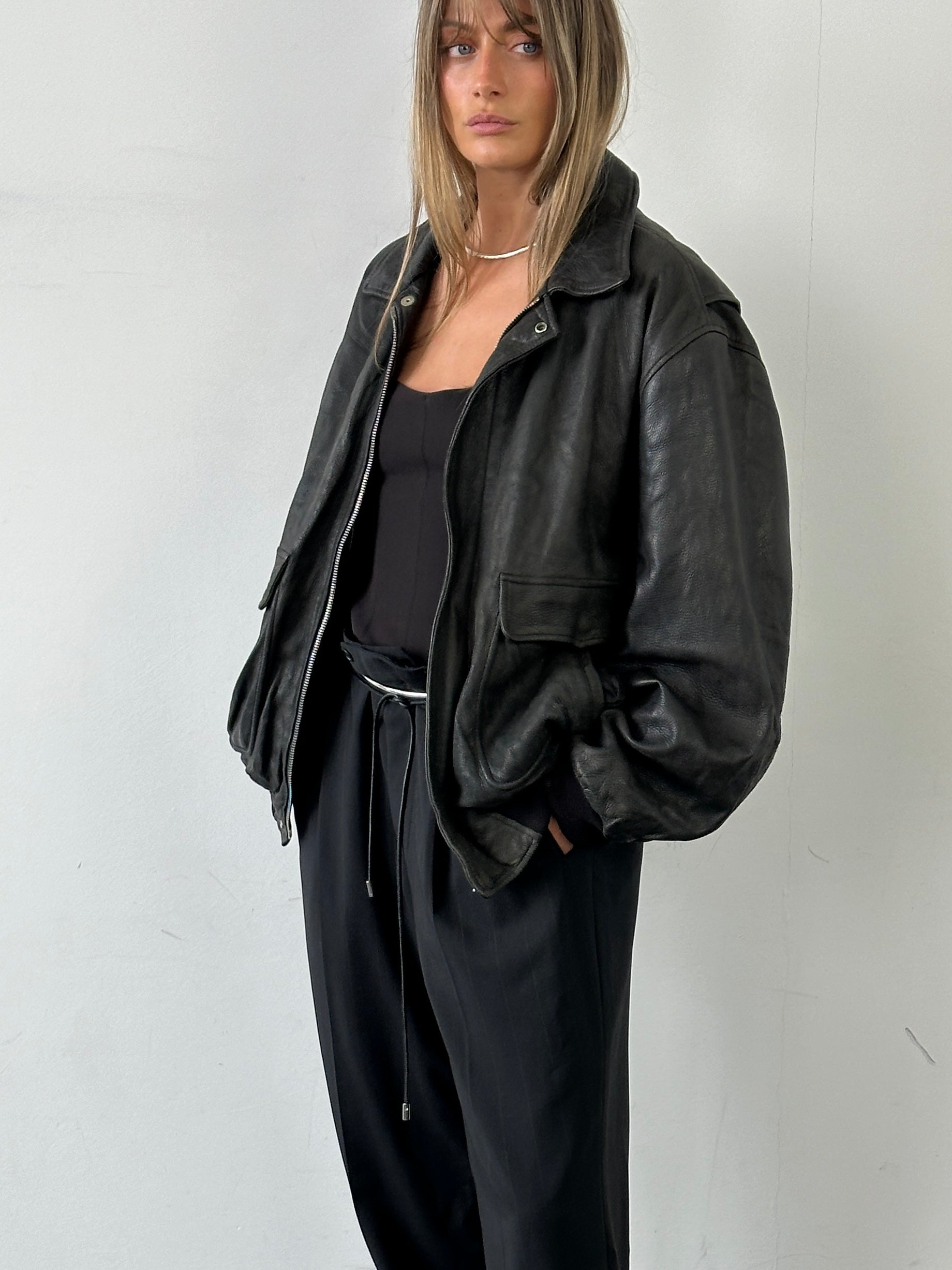 Vintage Italian aged leather bomber jacket in XL, showcasing classic design and distressed leather texture.