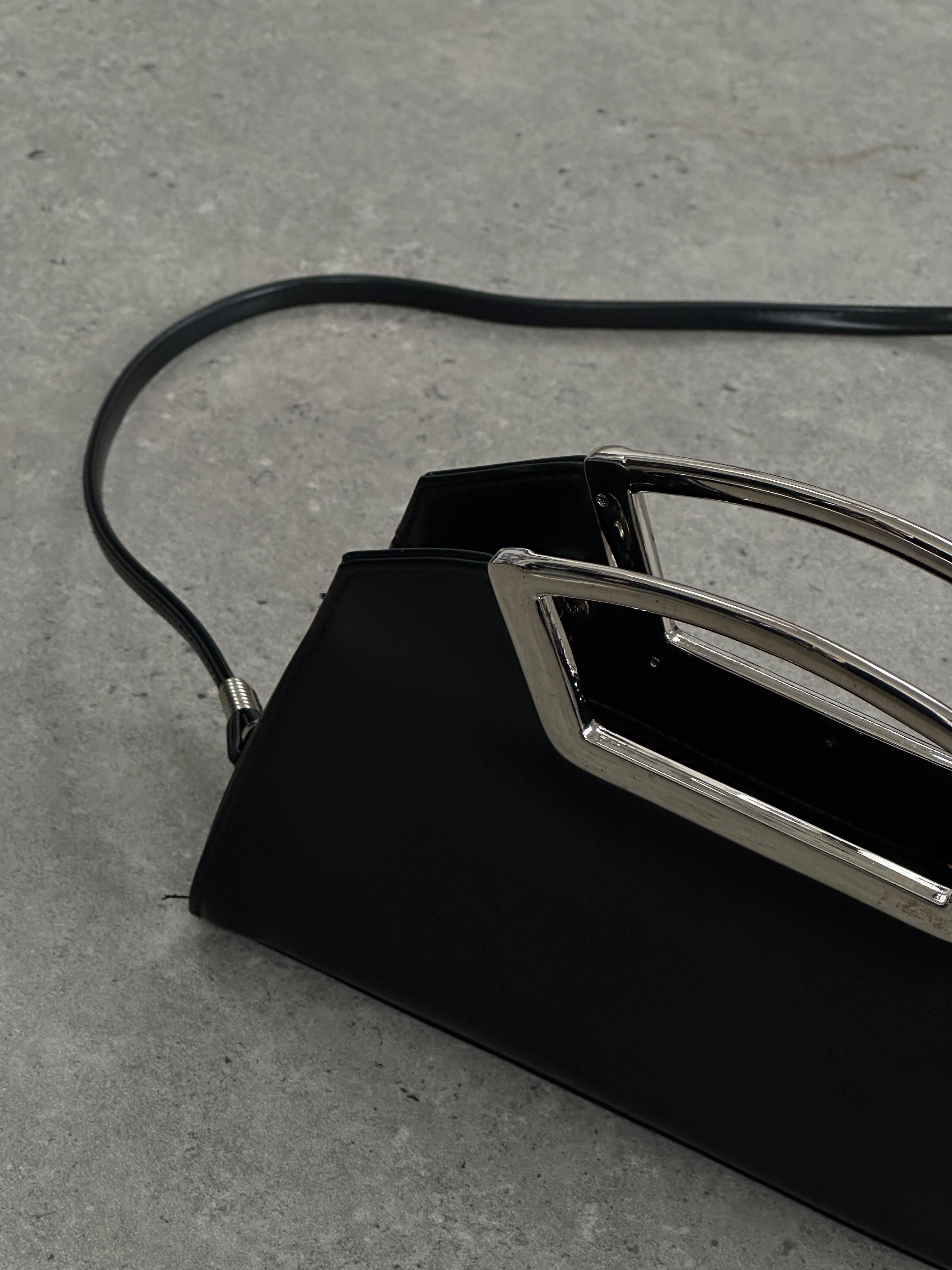 Vintage leather chrome crossbody clutch bag featuring a sleek design and adjustable strap, perfect for stylish everyday use.