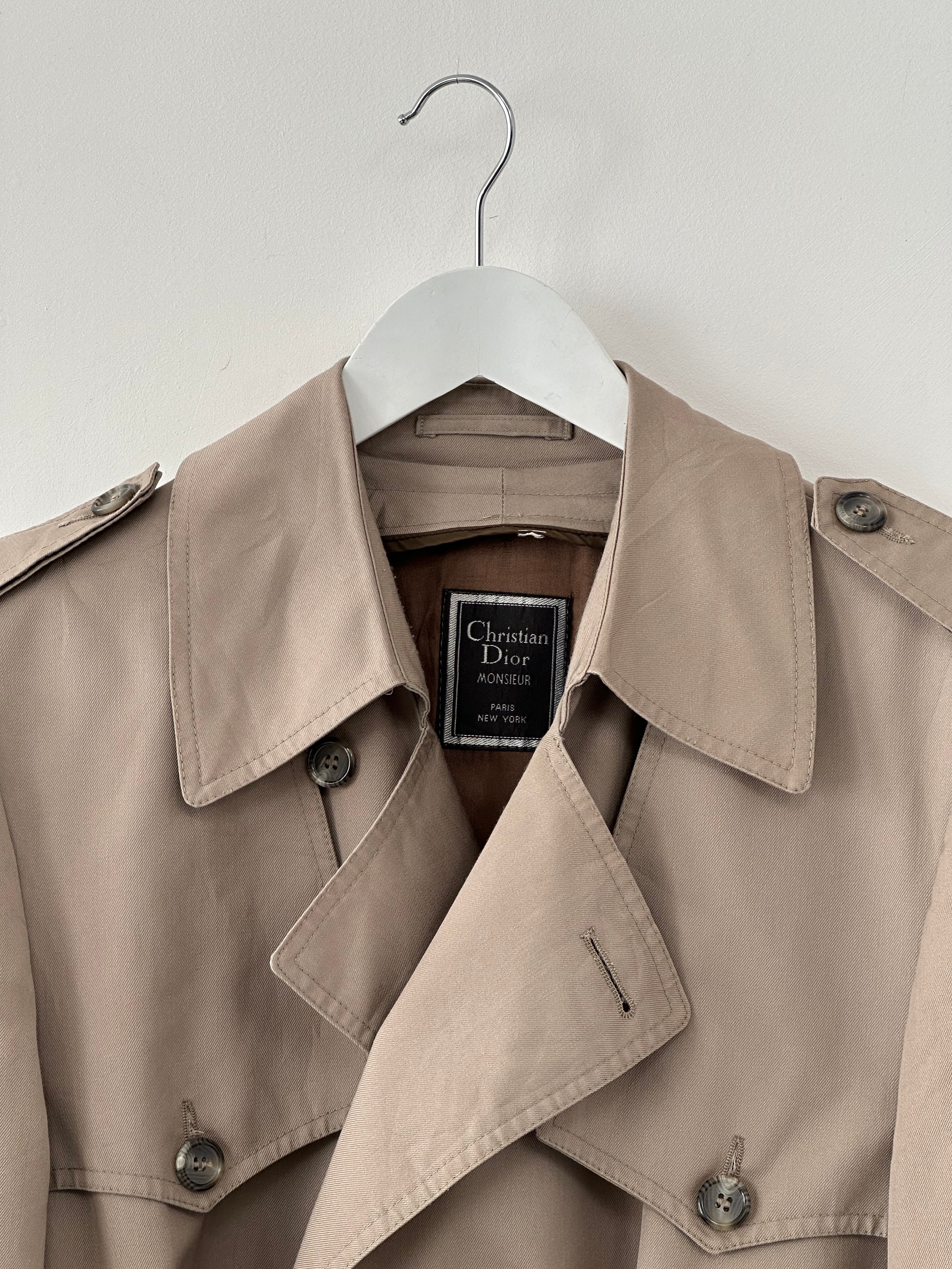 Christian Dior Monsieur cotton double-breasted belted trench coat in XL, shown on a model with classic beige color and stylish design.