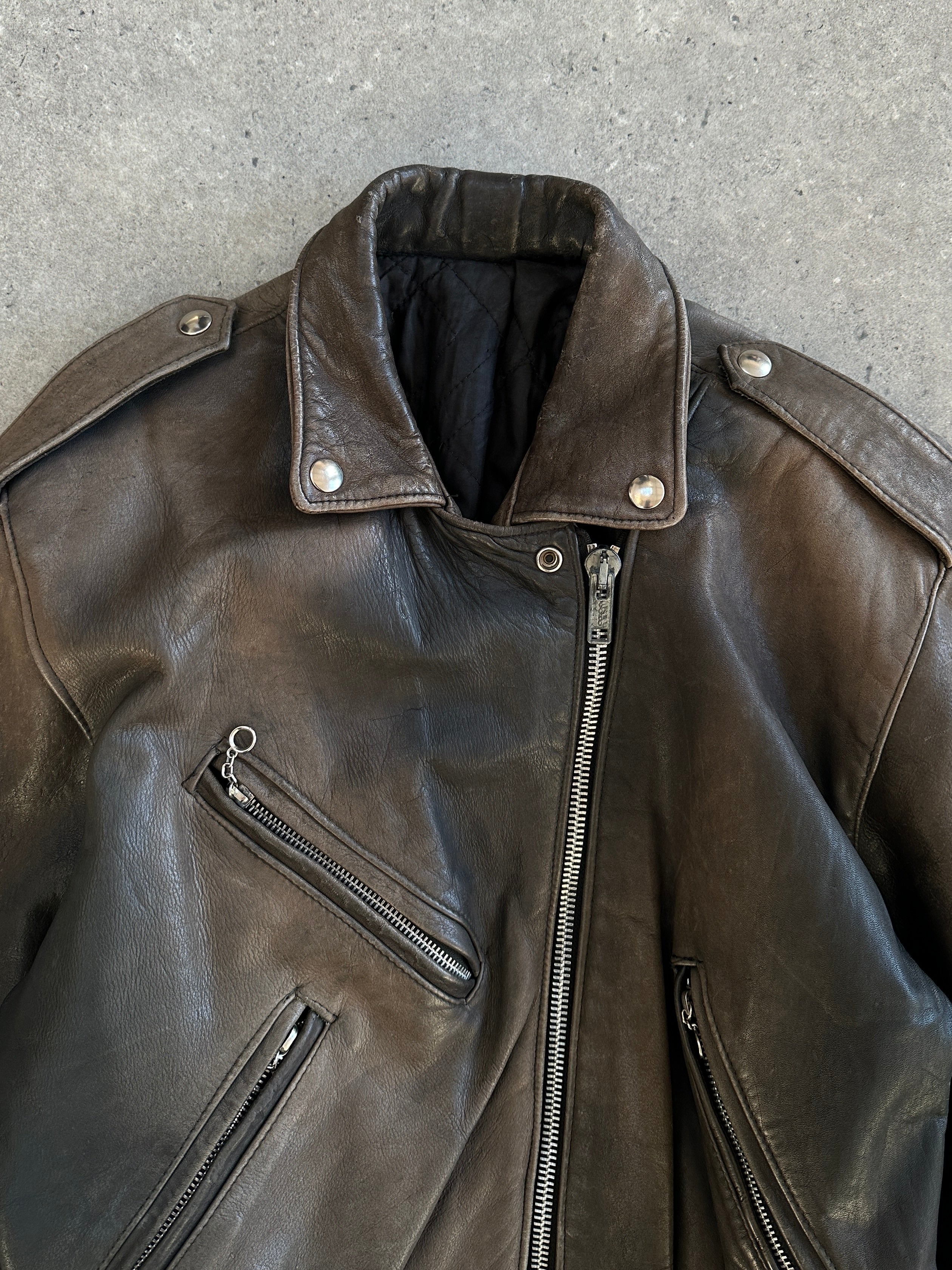 Vintage 1980s distressed leather biker jacket in size small, featuring rugged style and classic design details.