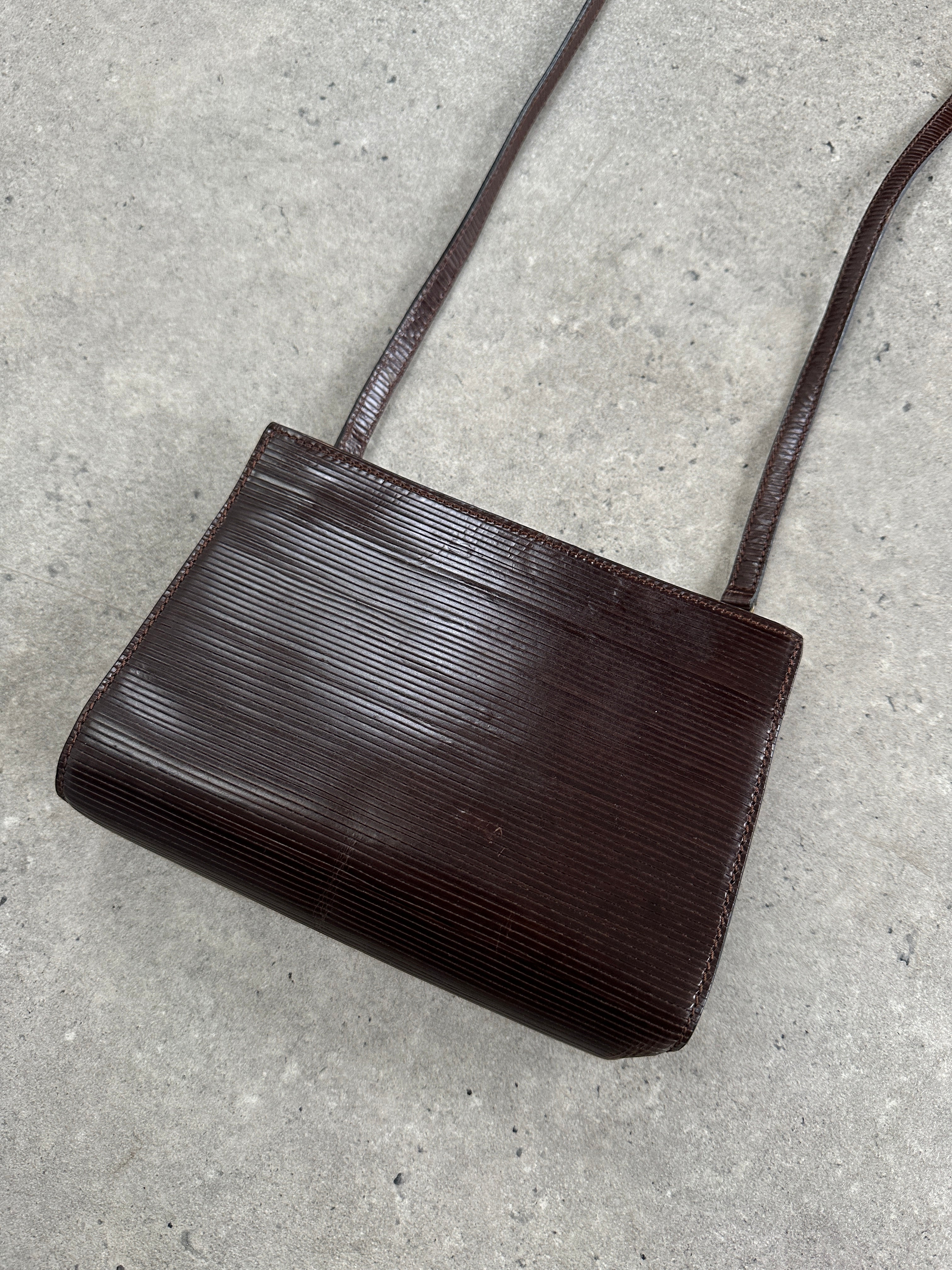 Giorgio Armani Le Collezioni 1990s leather crossbody bag with adjustable strap and classic design.