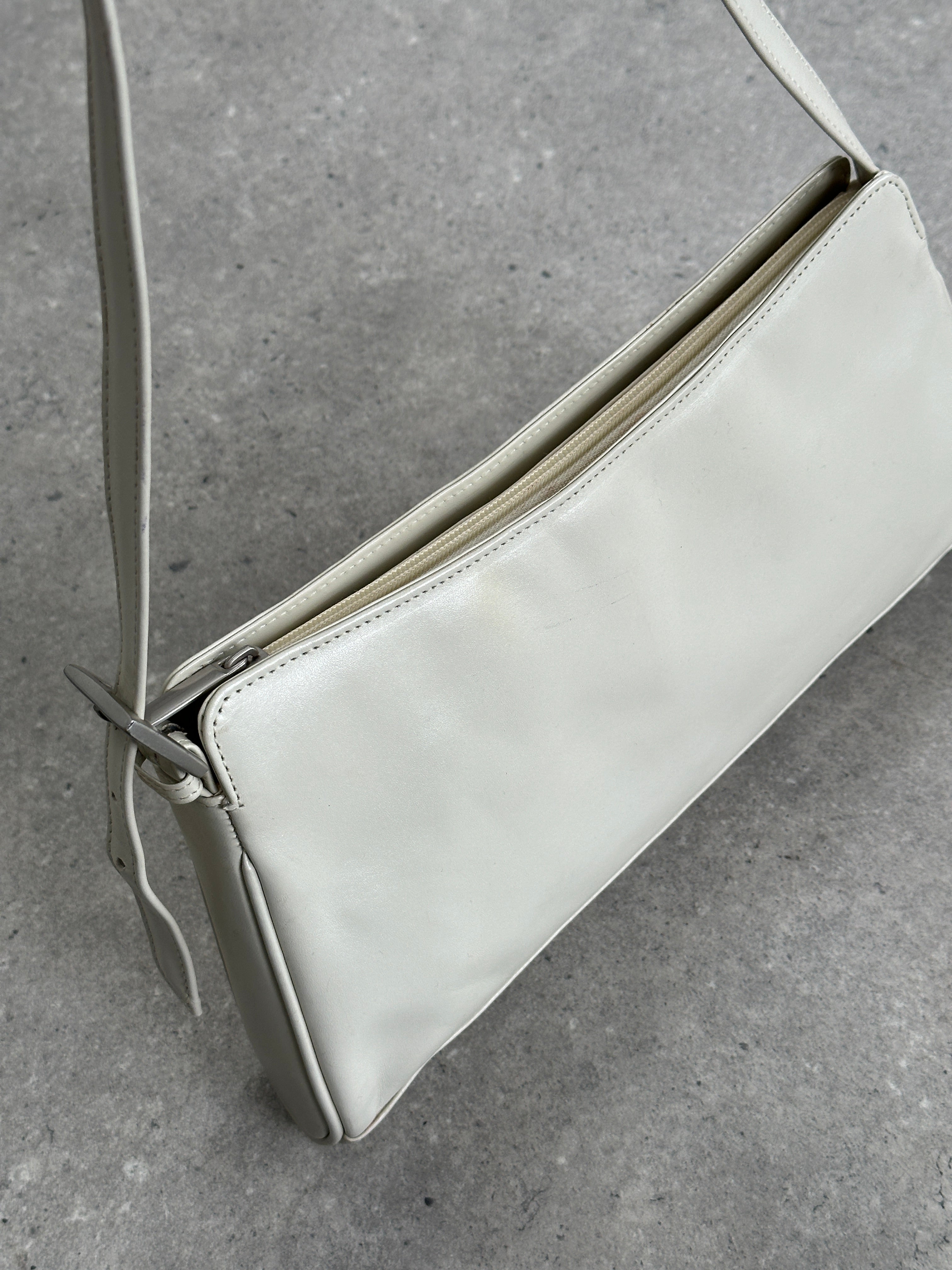 Vintage faux leather A-line shoulder bag with a sleek design, featuring a structured silhouette and subtle stitching details.