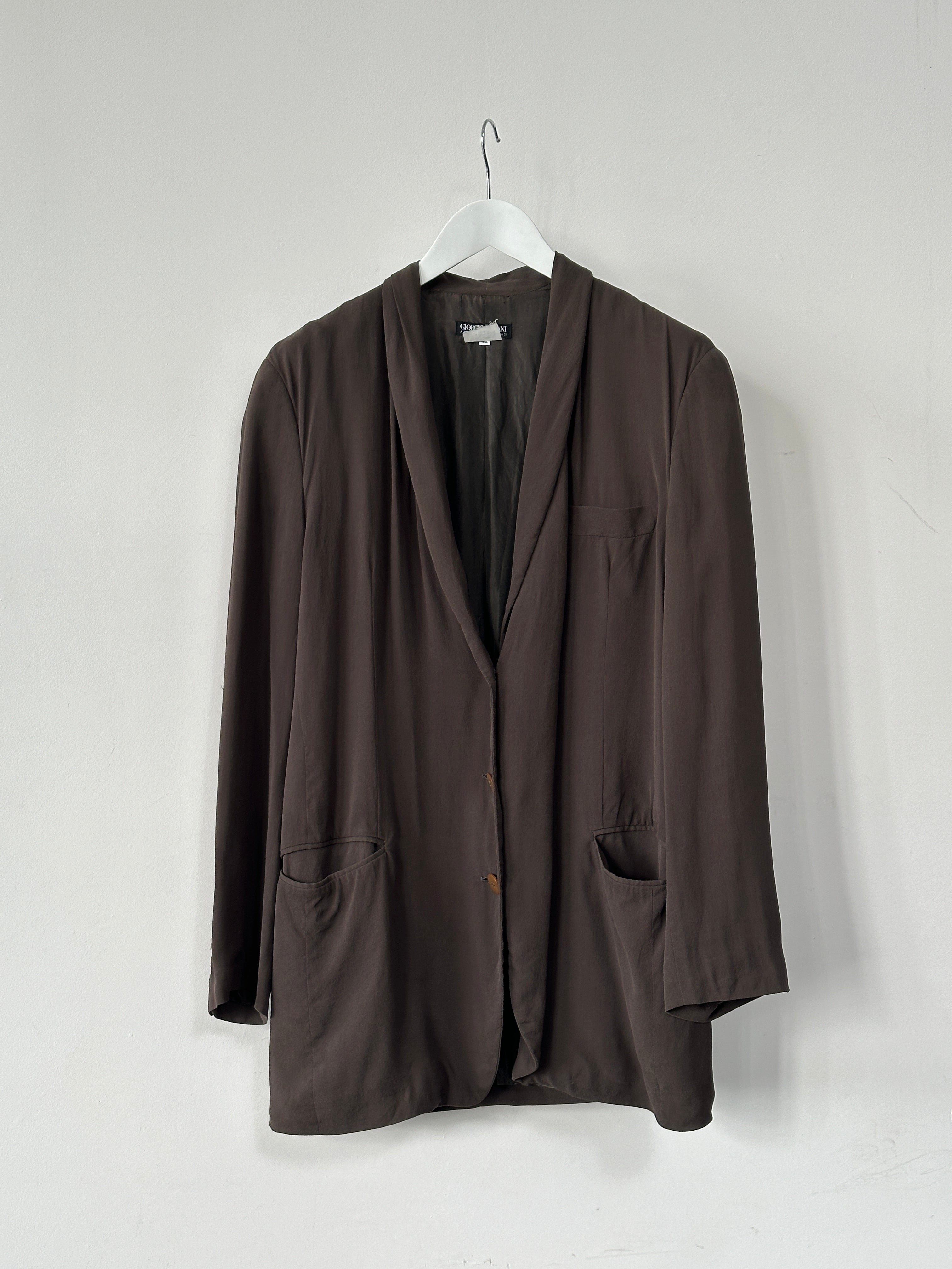 Giorgio Armani Black Label silk blazer in black, tailored fit, featuring sleek lapels and smooth fabric, displayed on a hanger.