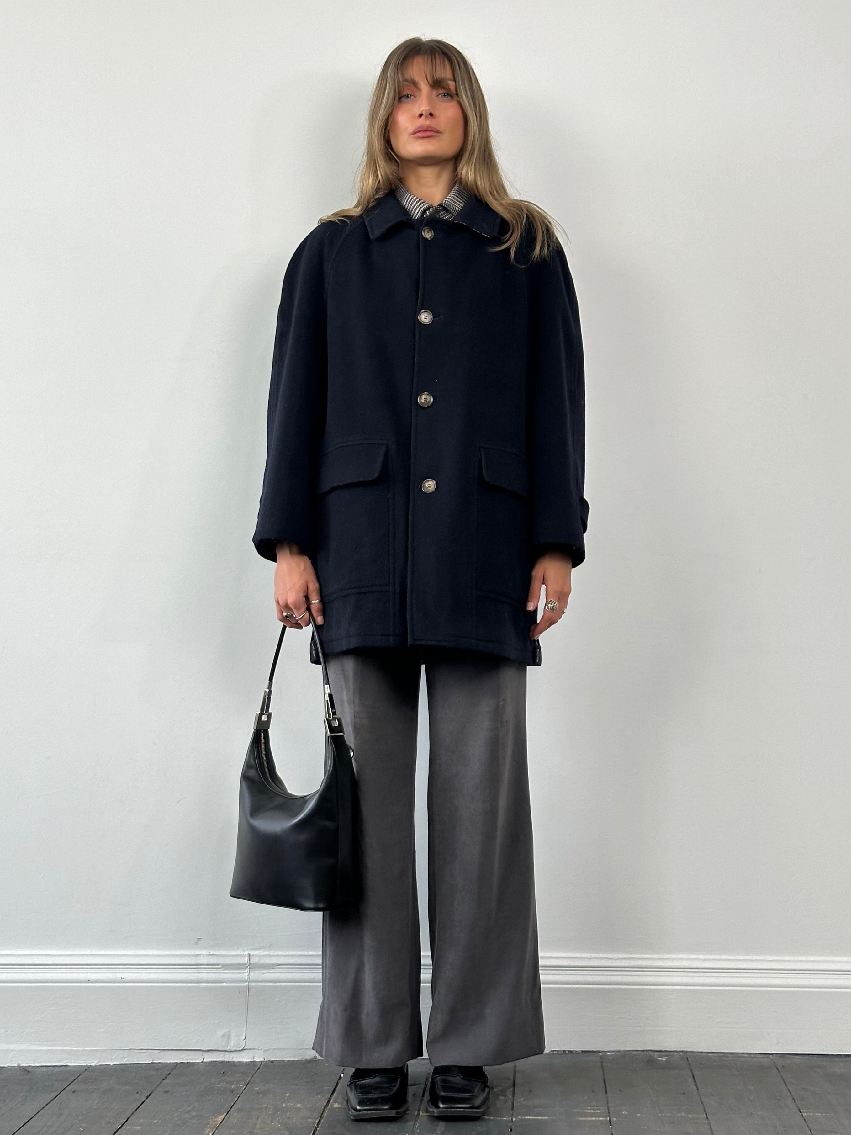 Burberry new wool single-breasted coat in XL size, featuring classic design and tailored fit, displayed on a hanger.