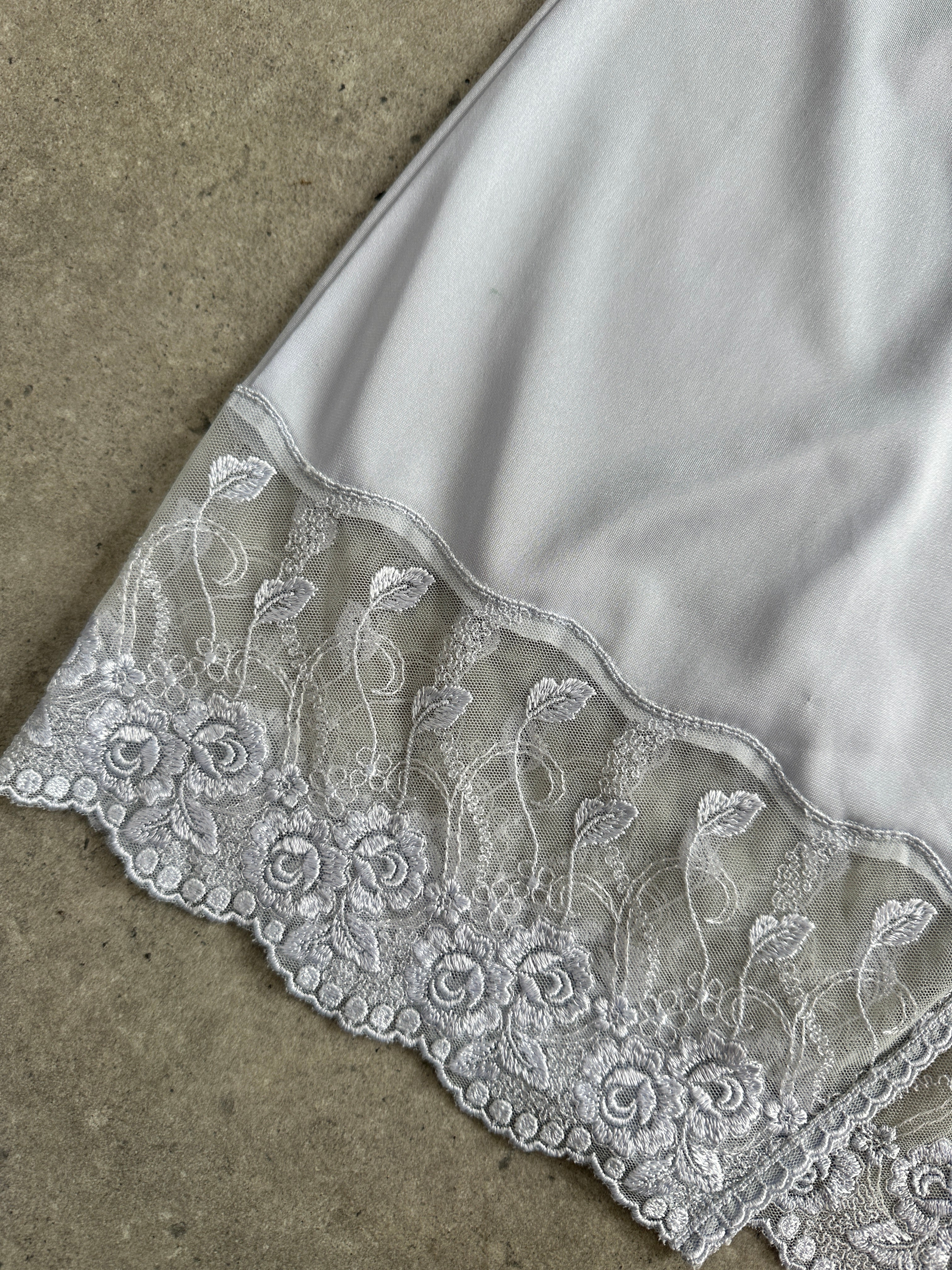 Vintage 1990s lace sheer mini slip dress, size small, featuring delicate lace fabric and vintage style.