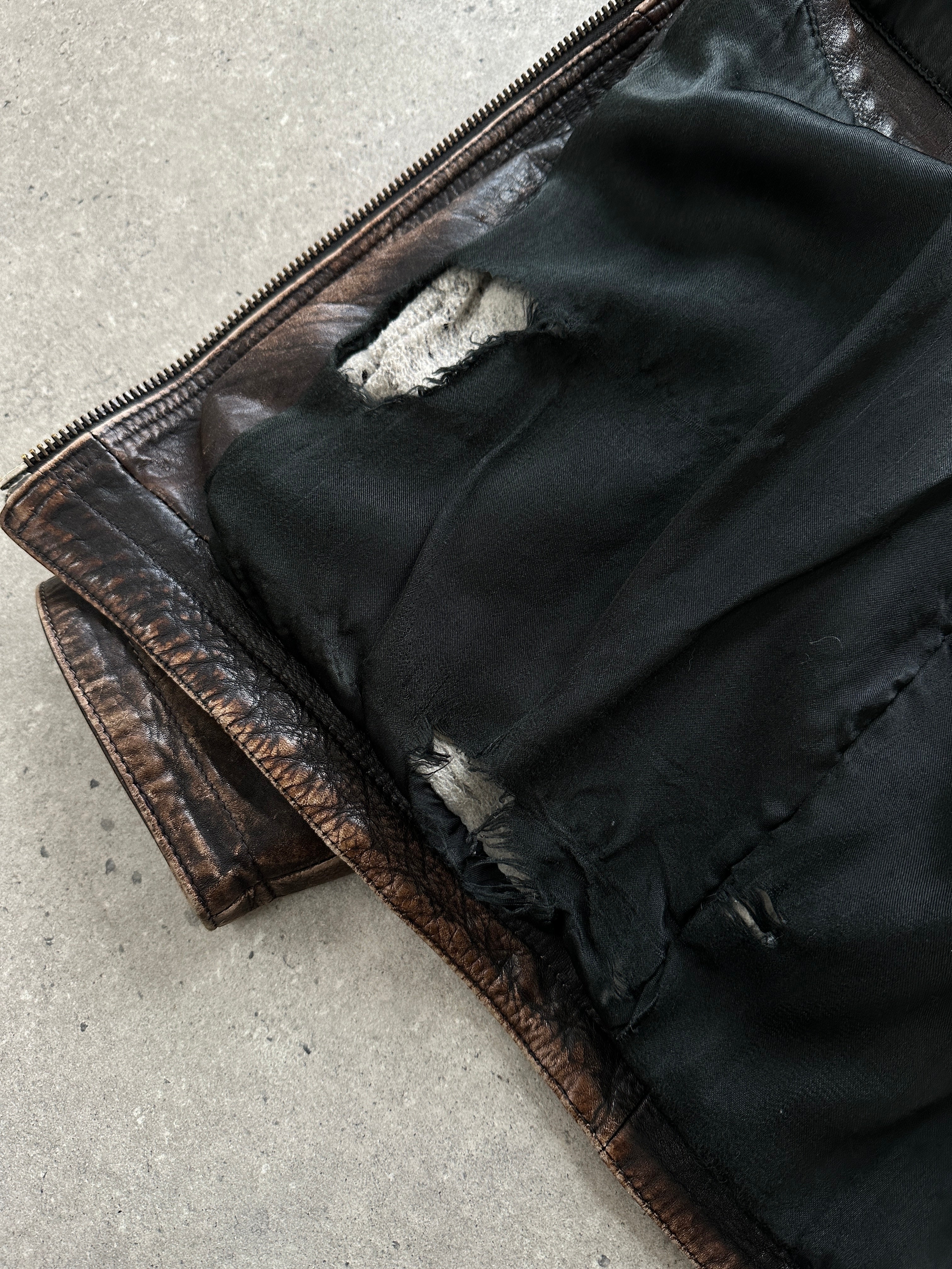 Vintage distressed leather jacket in size M/L with a rugged, worn-in look, featuring classic design and aged leather texture.