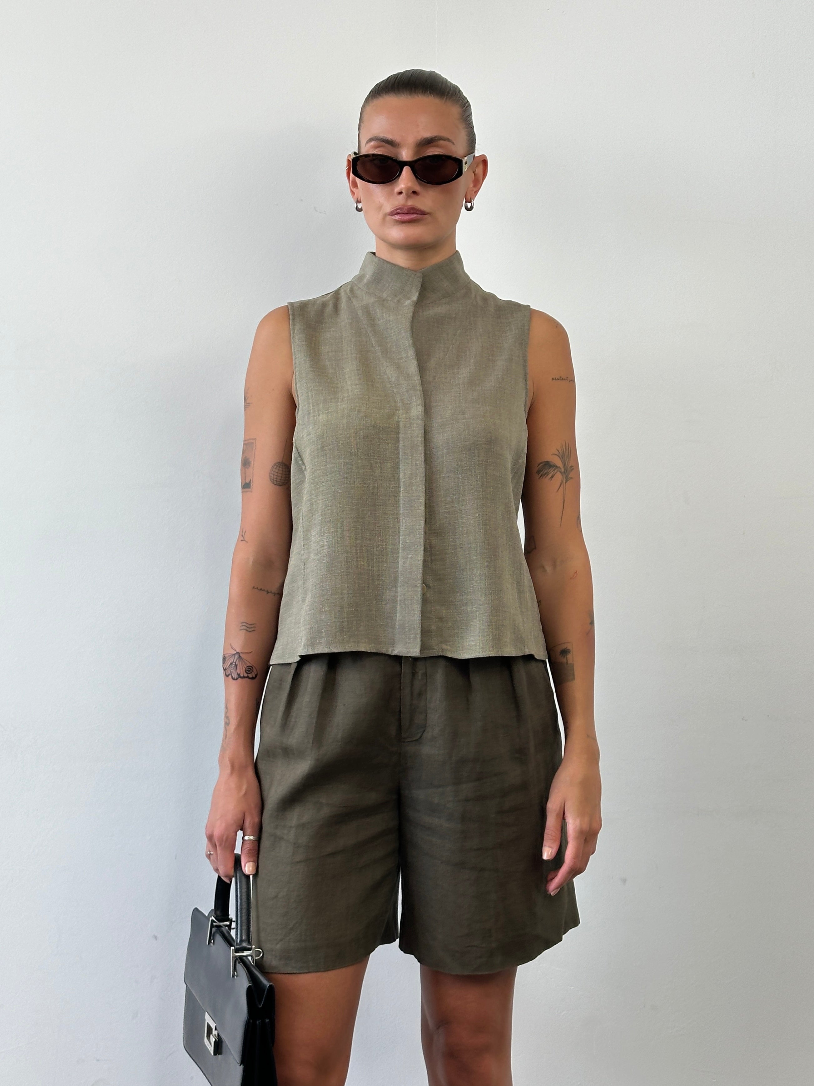 Vintage pure linen relaxed pleated shorts in size W26, showing the lightweight fabric and comfortable fit.