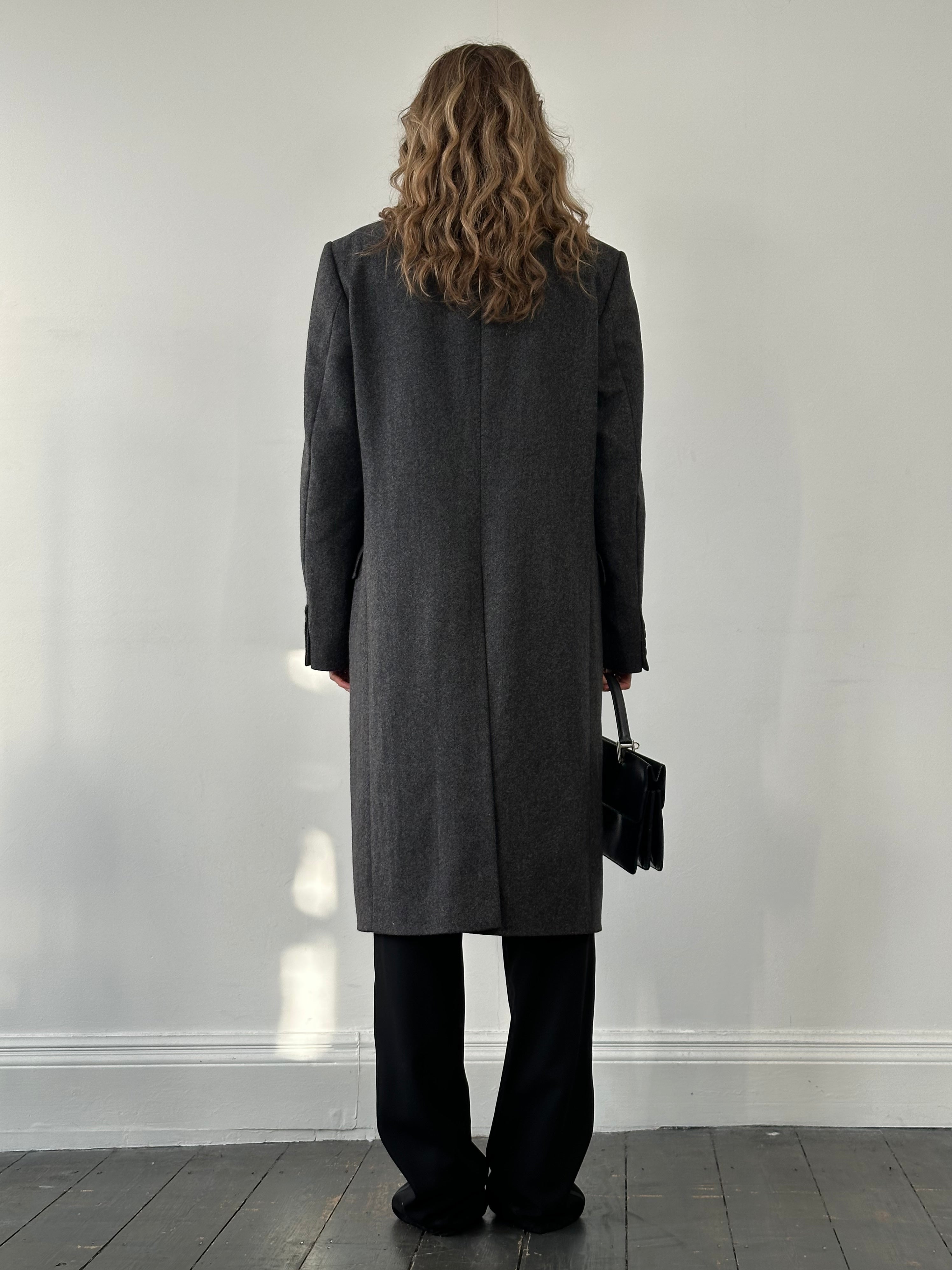 Christian Dior pure wool single-breasted coat in size L/XL, showcasing a tailored design with classic lapel details.