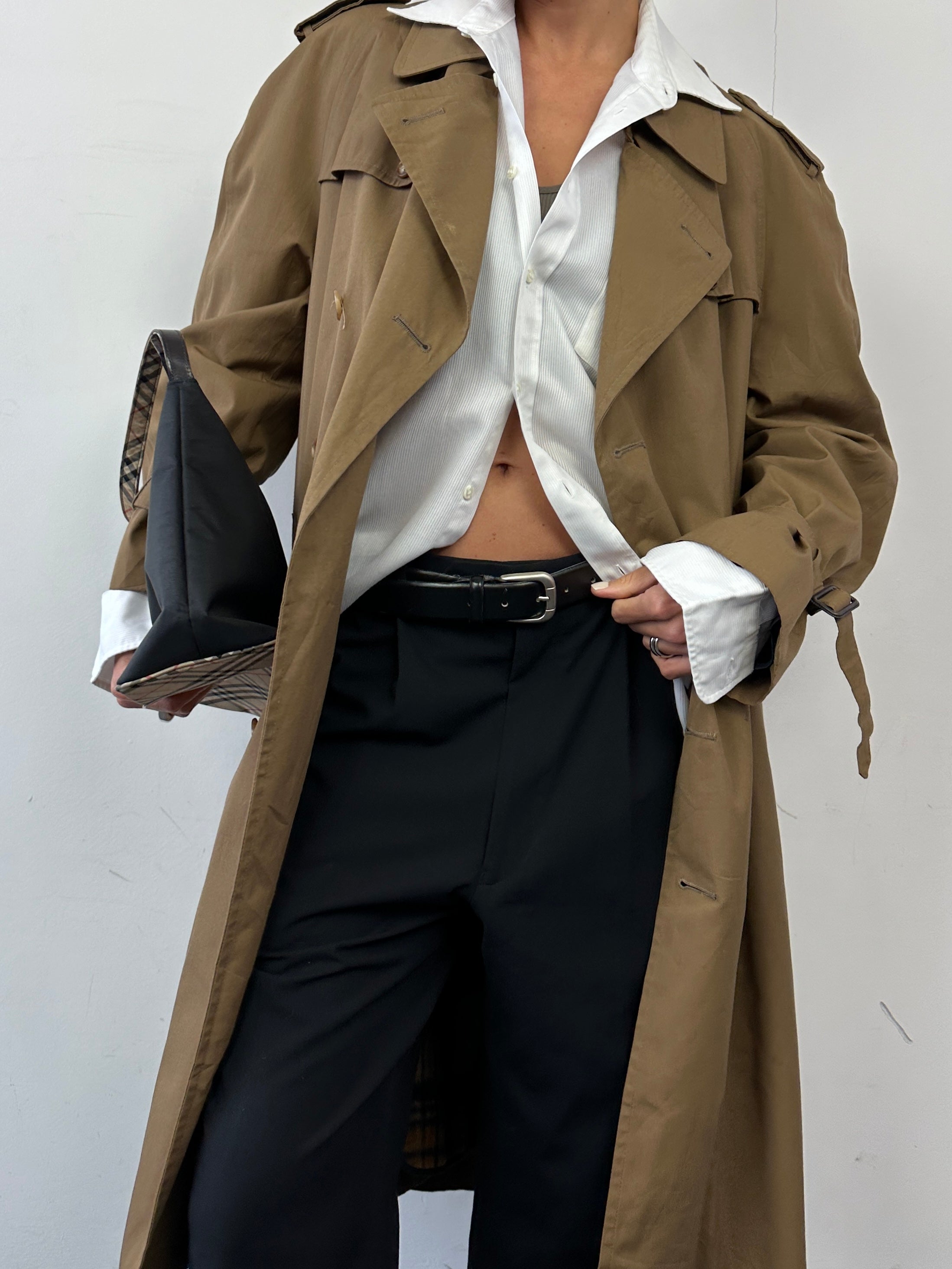 Christian Dior cotton double-breasted trench coat in size L, shown hanging with classic design and neutral color.