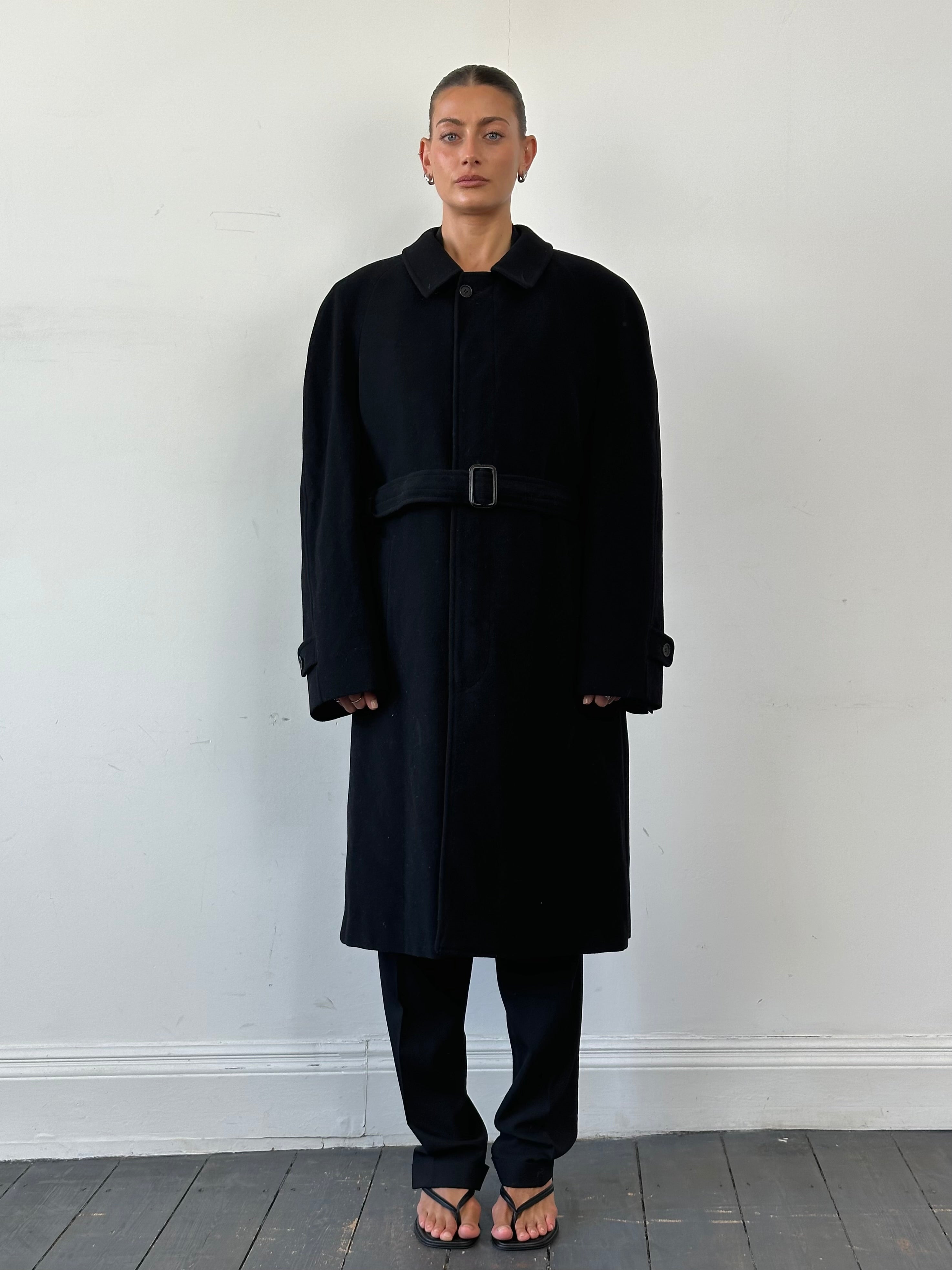 Giorgio Armani Le Collezioni belted wool coat in XXL, draped on a hanger, showcasing classic design and luxurious fabric.