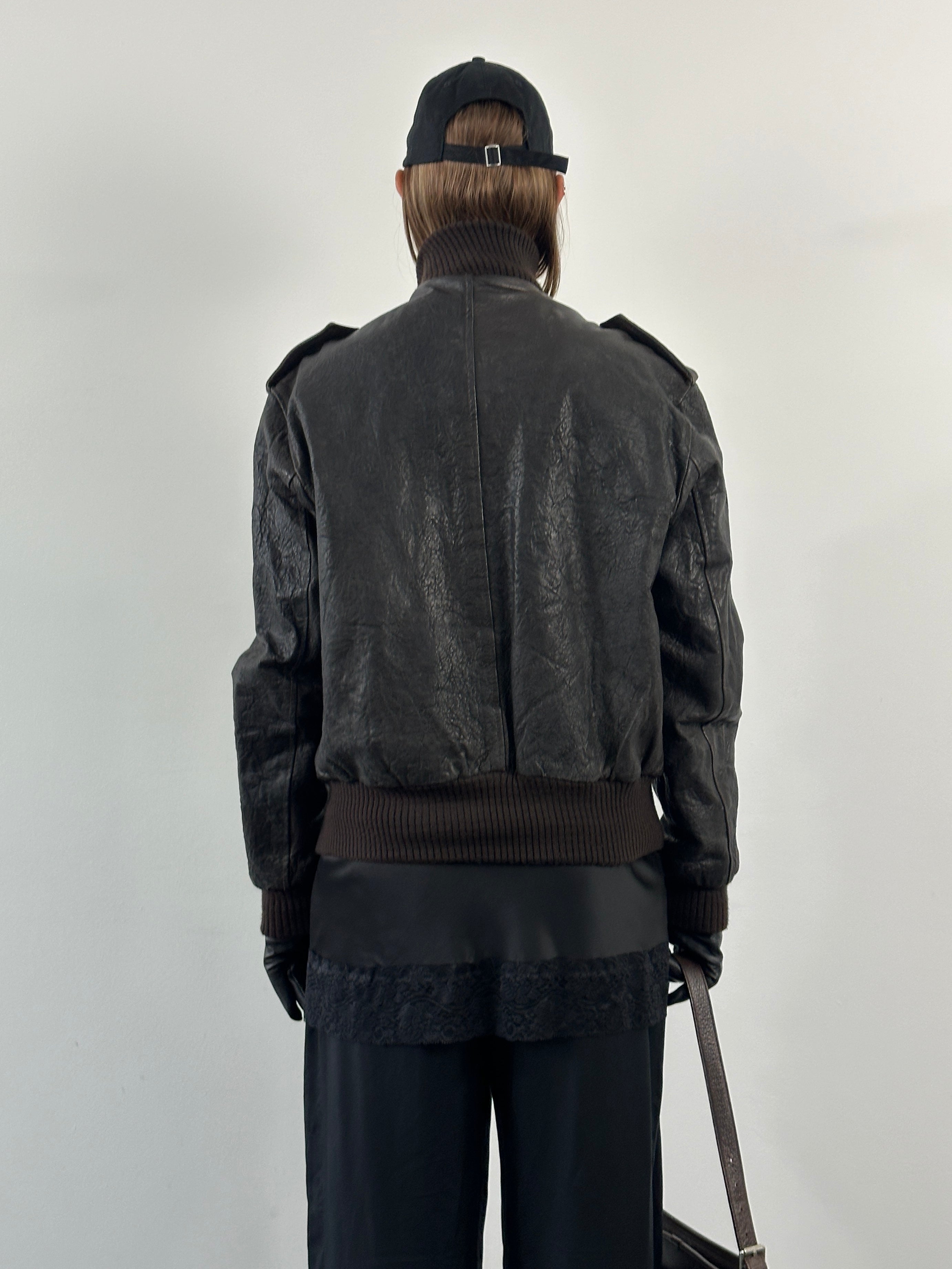 Vintage Italian leather bomber jacket with textured high neck design, in size large, featuring classic vintage style.