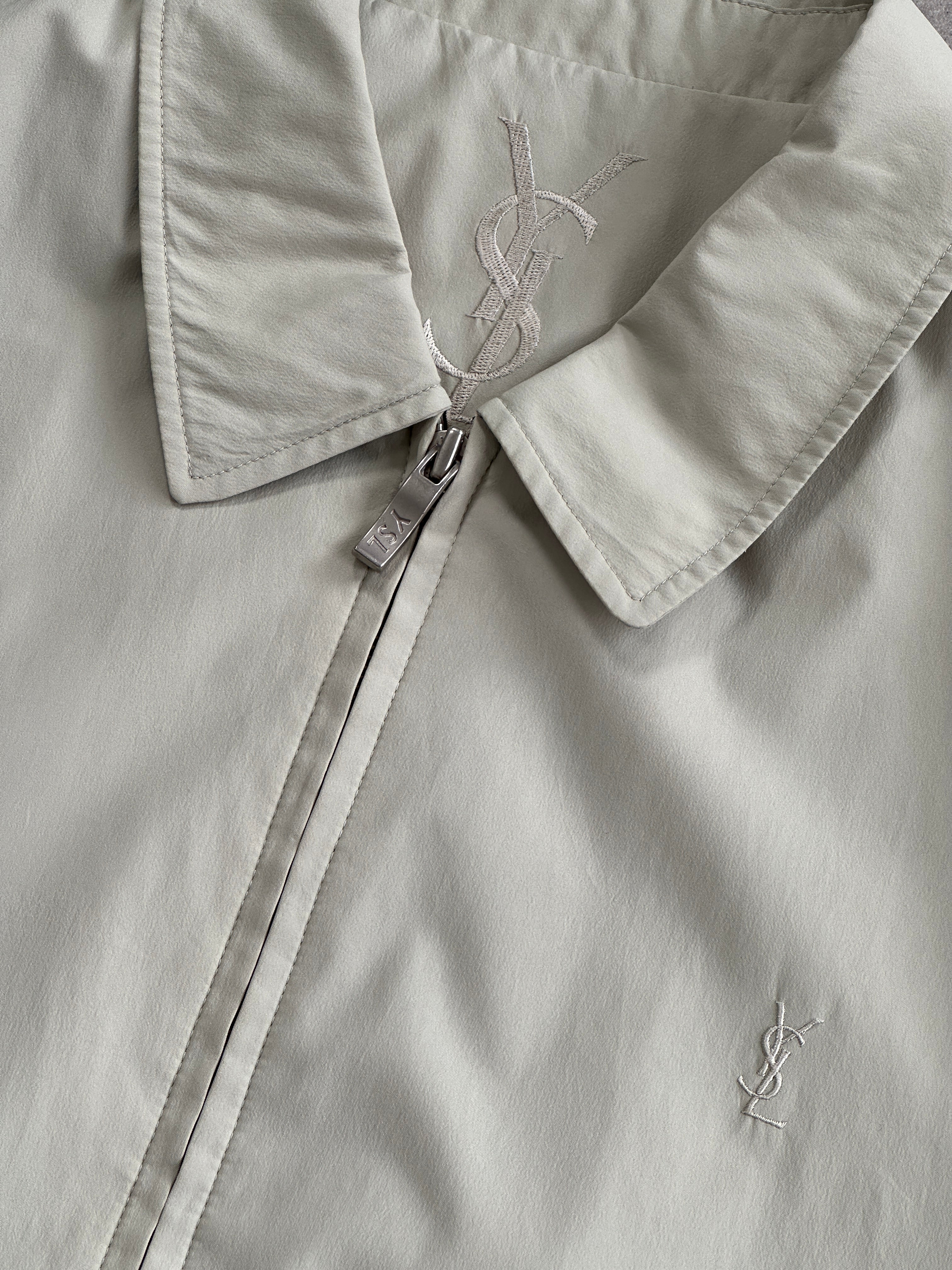 Yves Saint Laurent Pour Homme logo bomber jacket in black, featuring a front zipper, ribbed cuffs, and logo detail on the chest.