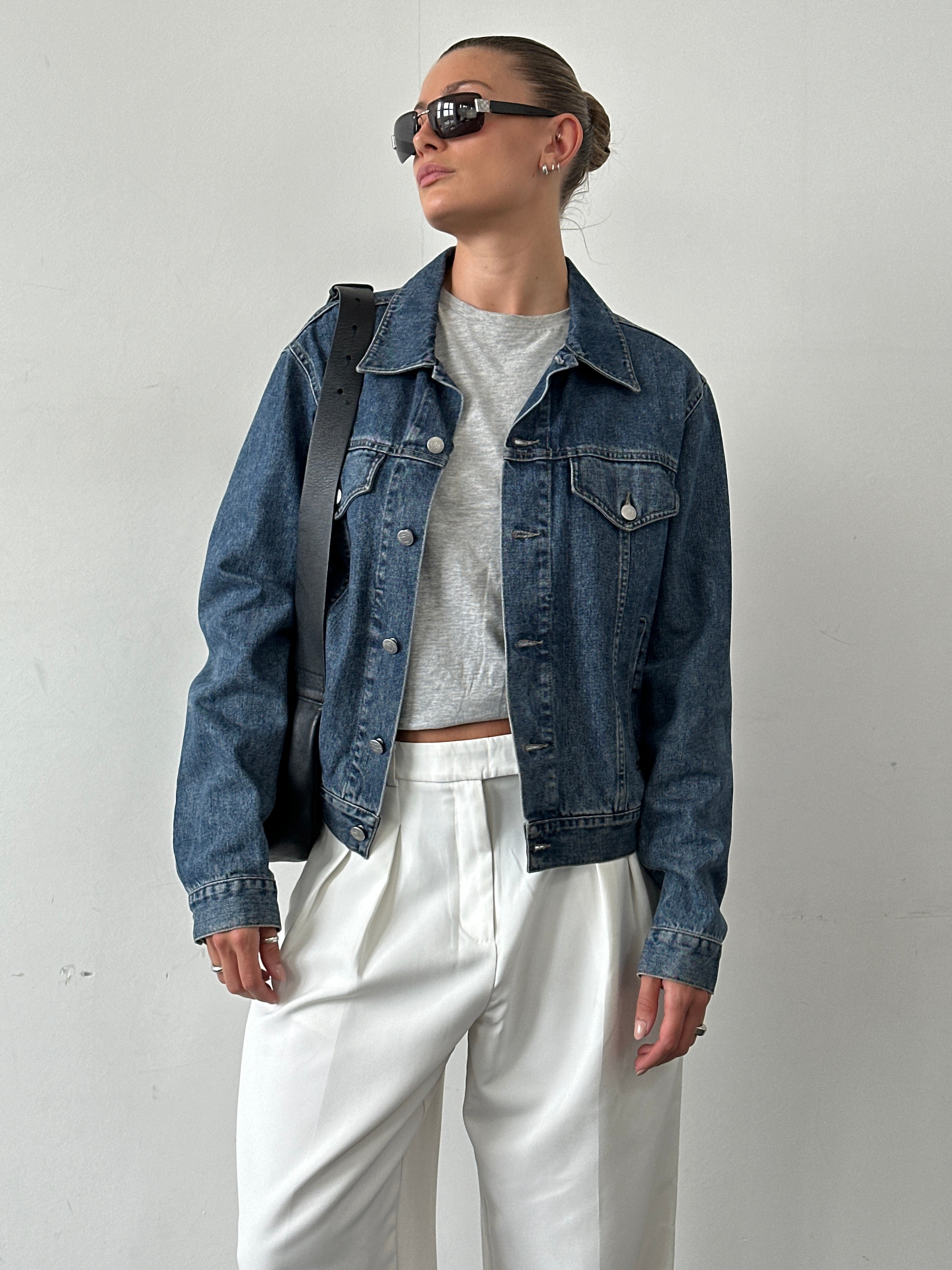 Armani Jeans denim jacket in size M, featuring classic blue denim with front pockets and button closure, casual style.