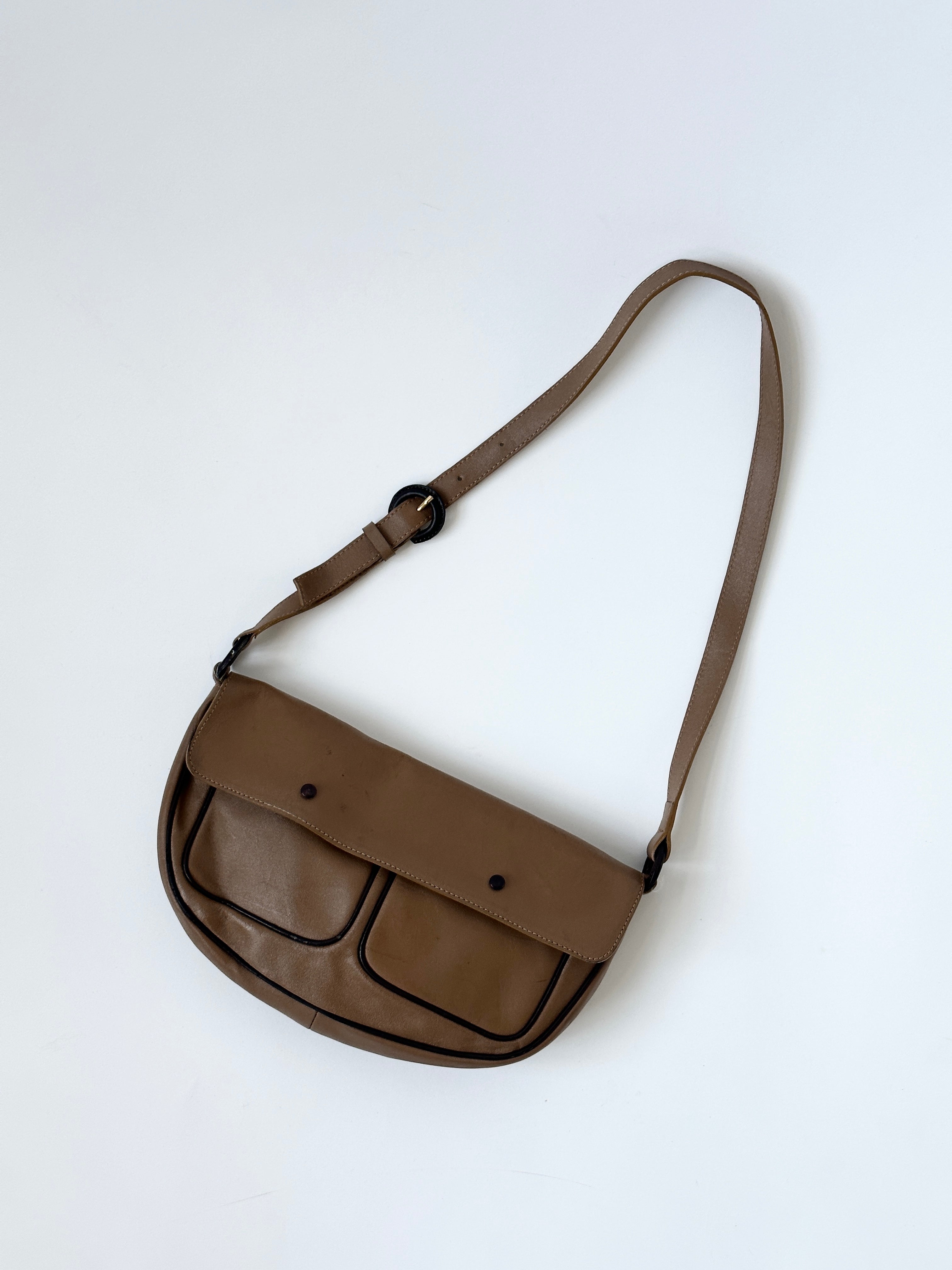 Vintage Italian leather crescent crossbody bag with adjustable strap and classic design, featuring a rich, aged leather finish.
